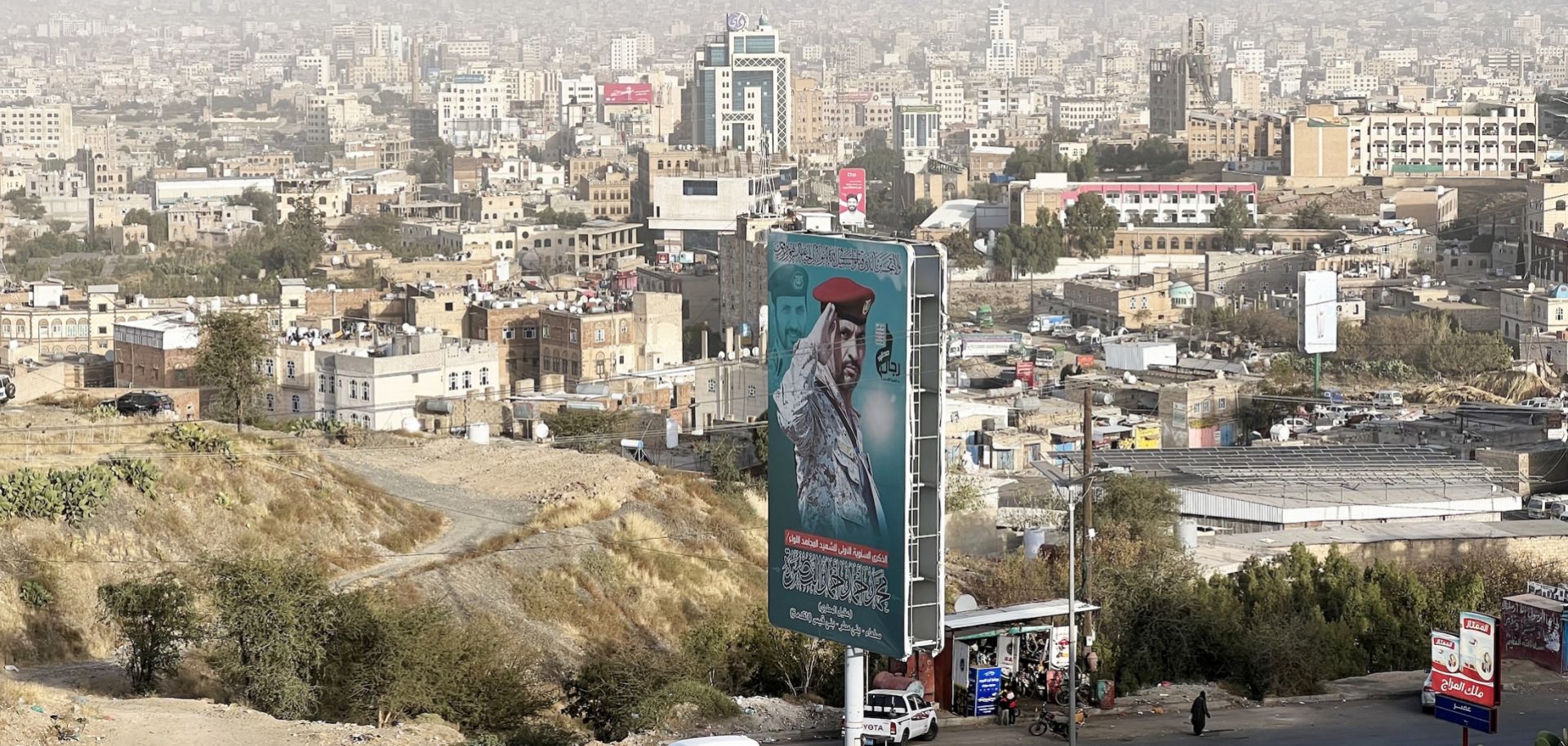 A billboard depicting a Houthi military official who was killed during Yemen's civil war overlooks the Yemeni capital city of Sanaa on Jan. 2, 2025. 