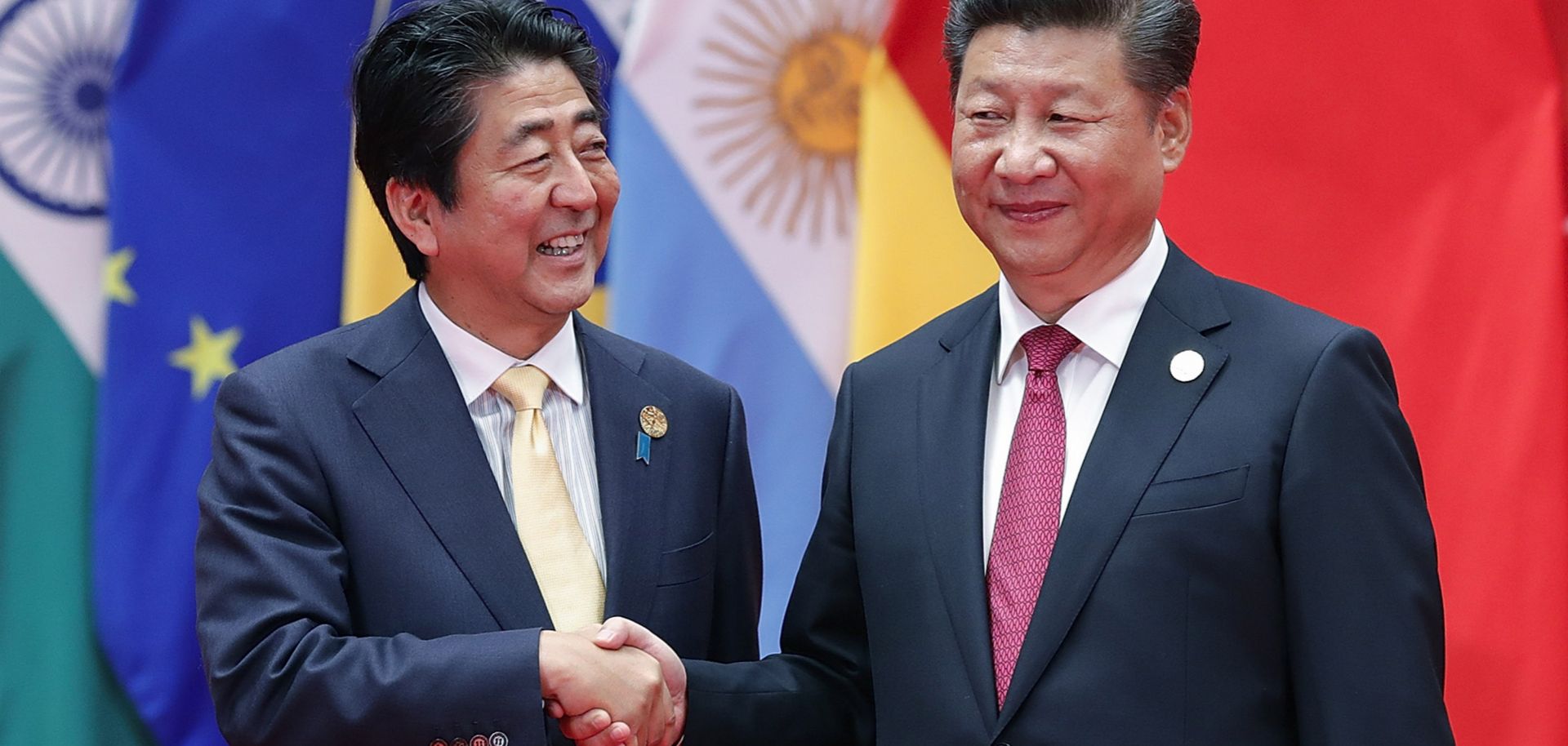Japanese Prime Minister Shinzo Abe (L) and Chinese President Xi Jinping shake hands at the 2016 G-20 Summit.