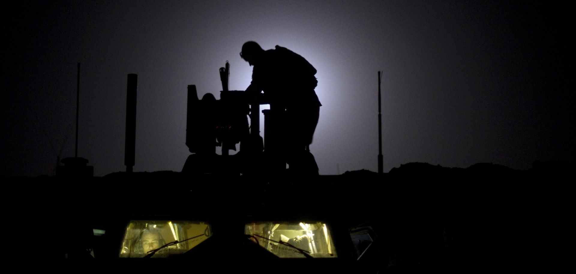 As the 10th anniversary of the Afghanistan War neared in 2011, a U.S. soldier readies his weapon at a forward operating base.