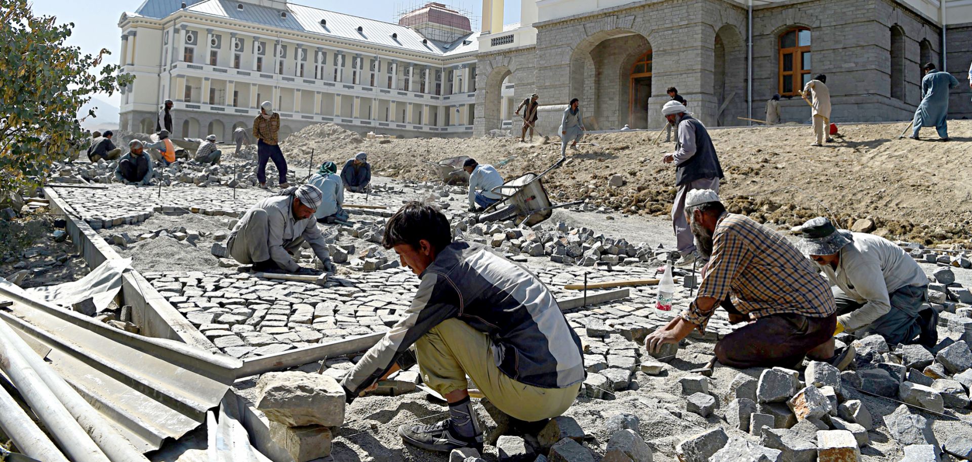 Afghan laborers work on the exterior renovation of Darulaman Palace in Kabul on Aug. 8, 2019.