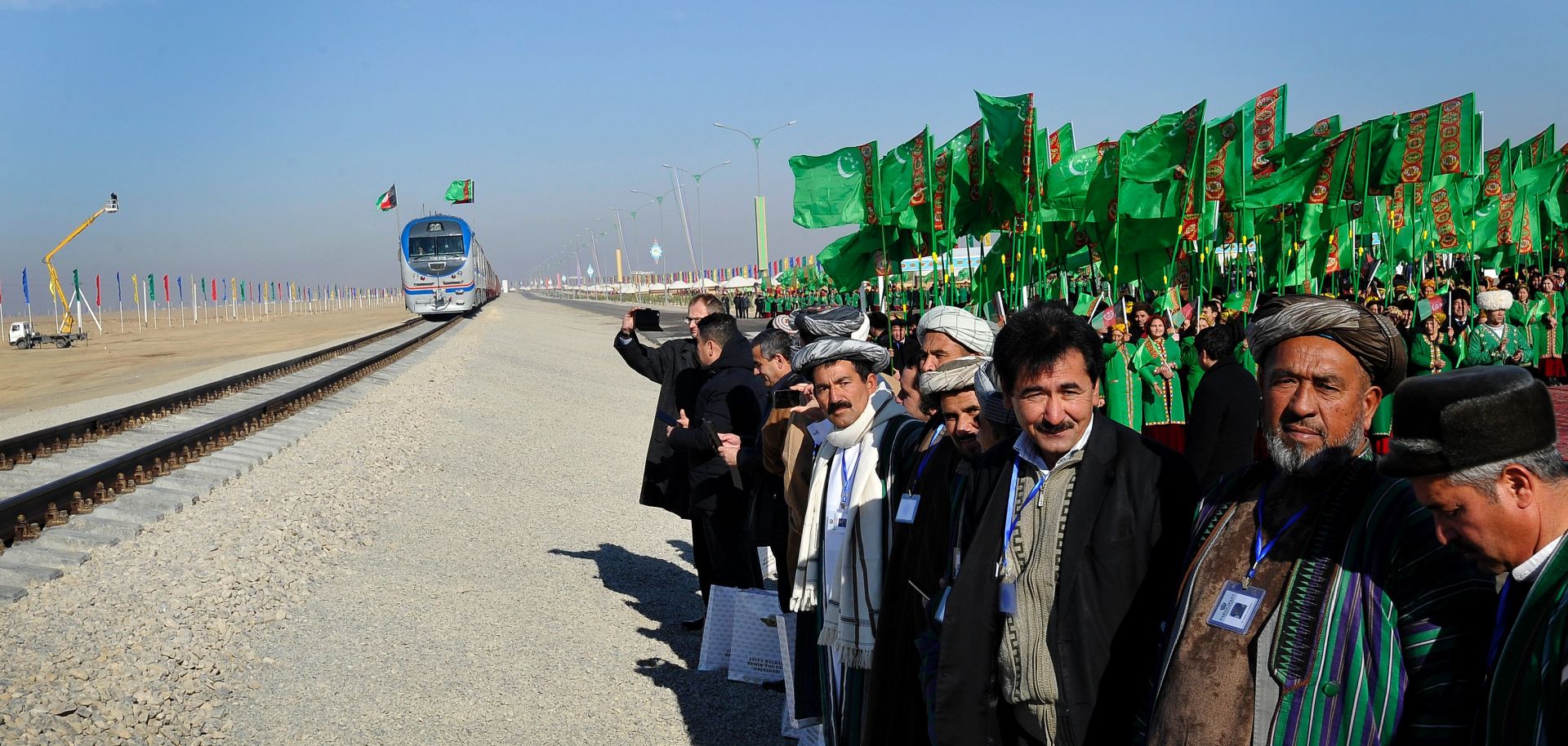 People gather at the Imamnazar customs point during a ceremony for the opening of the first section of a $2 billion railway link between Turkmenistan and Afghanistan.