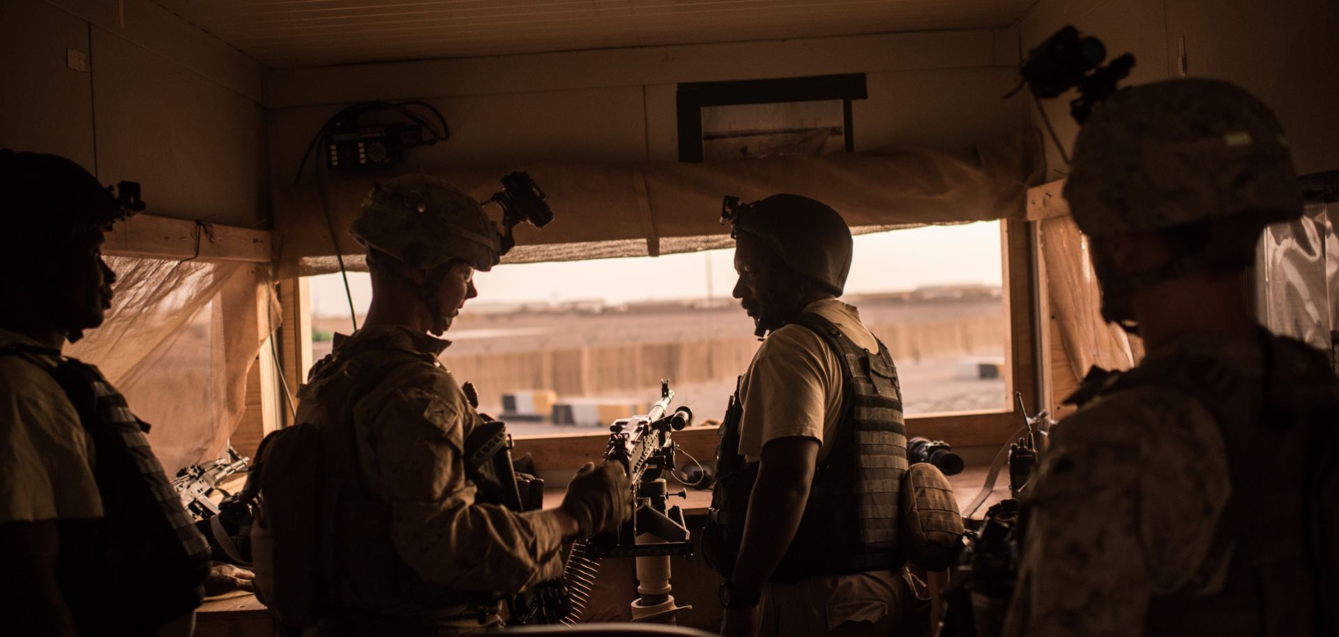 U.S. marines talk to Ugandan contractors at a guard station in Helmand Province, Afghanistan.