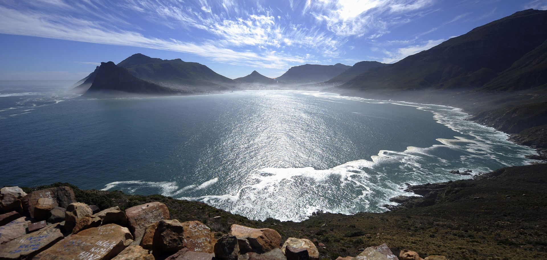 A general view of the Hout Bay harbour covered in mist is seen on May 8, 2010 from the Chapman's peak road on the outskirts of Cape Town. Chapman's peak road is the coastal link between Cape Town and the Cape of Good Hope. When following the African coastline from the equator the Cape of Good Hope marks the psychologically important point where one begins to travel more eastward than southward, thus the first rounding of the cape in 1488 by Portuguese explorer Bartolomeu Dias was a major milestone in the at