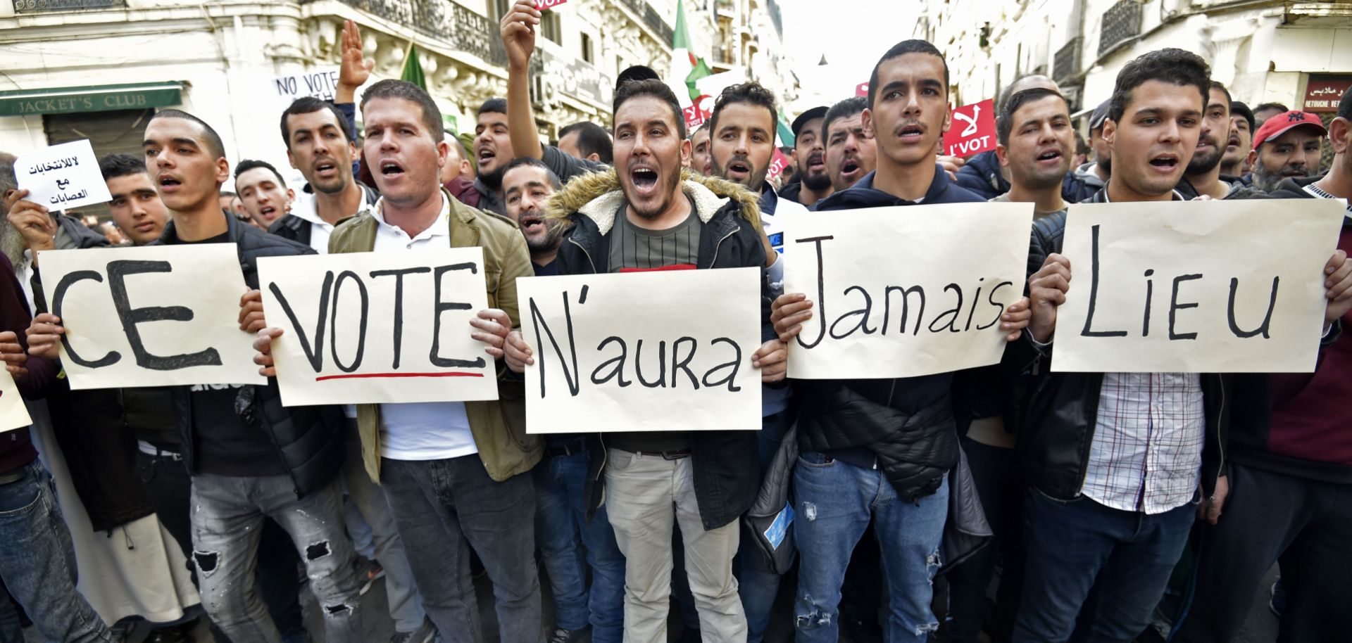 Algerian demonstrators carry placards reading "This vote will never take place" in French in regard to the Dec. 12 presidential election, during a march in Algiers on Dec. 6, 2019.