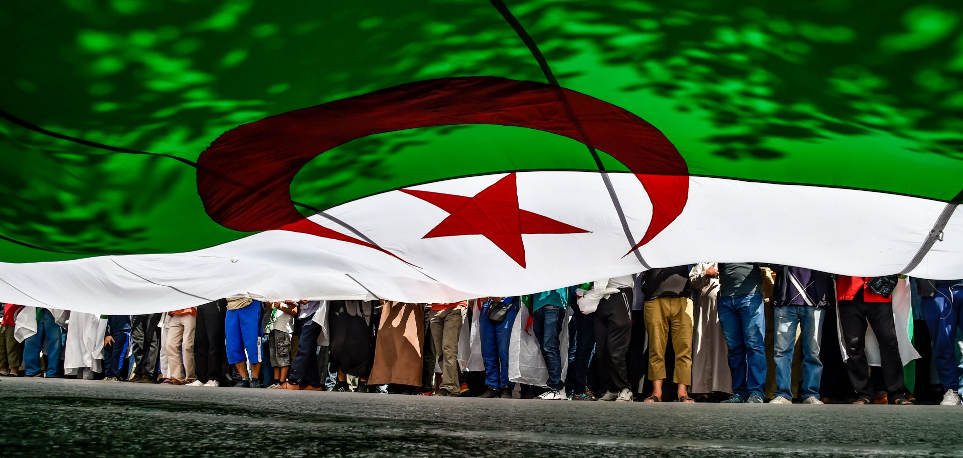 Protesters bearing an Algerian flag march in Algiers on May 31, 2019.