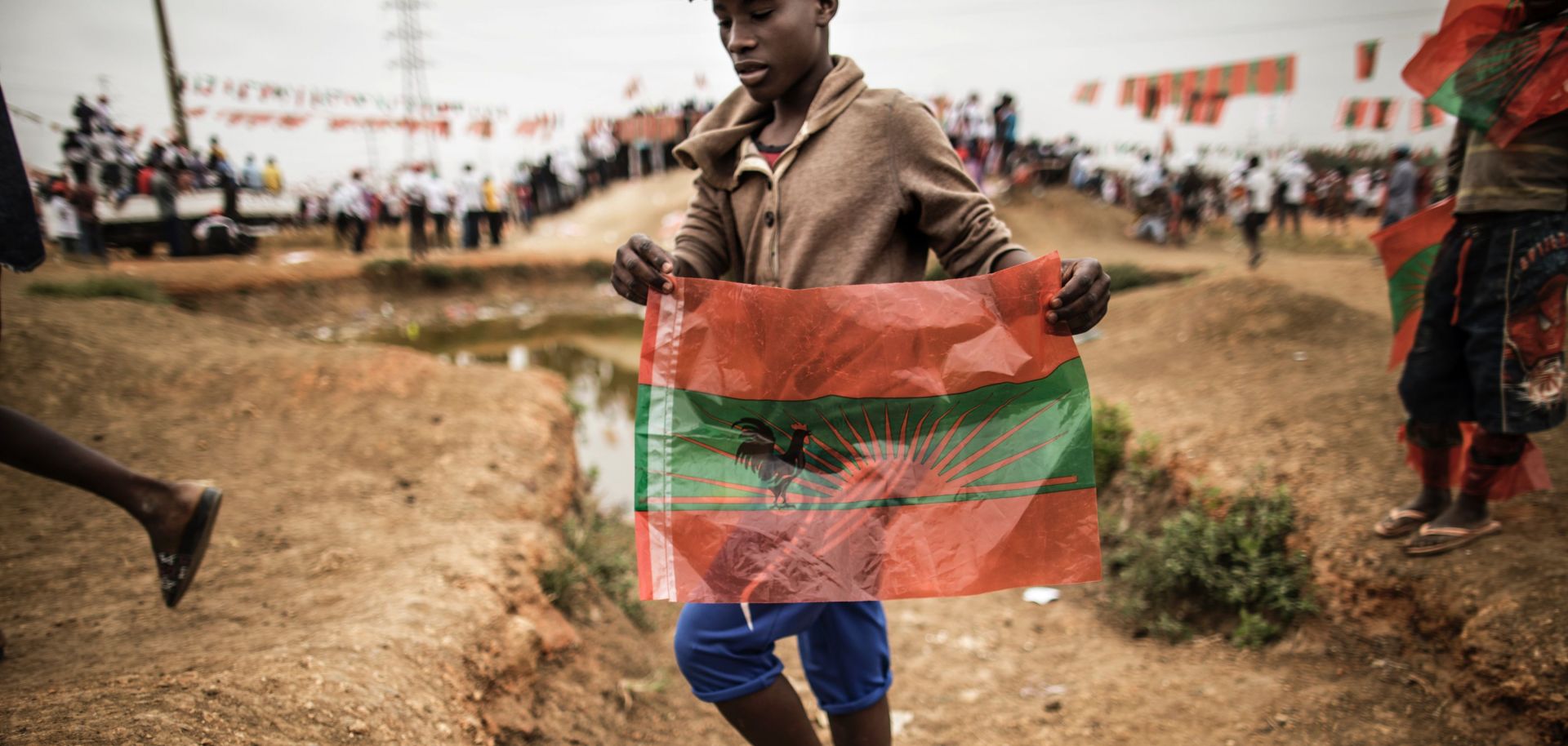 In Angola, a supporter brandishes the flag of the opposition National Union for the Total Independence of Angola party just days before the country's general elections.