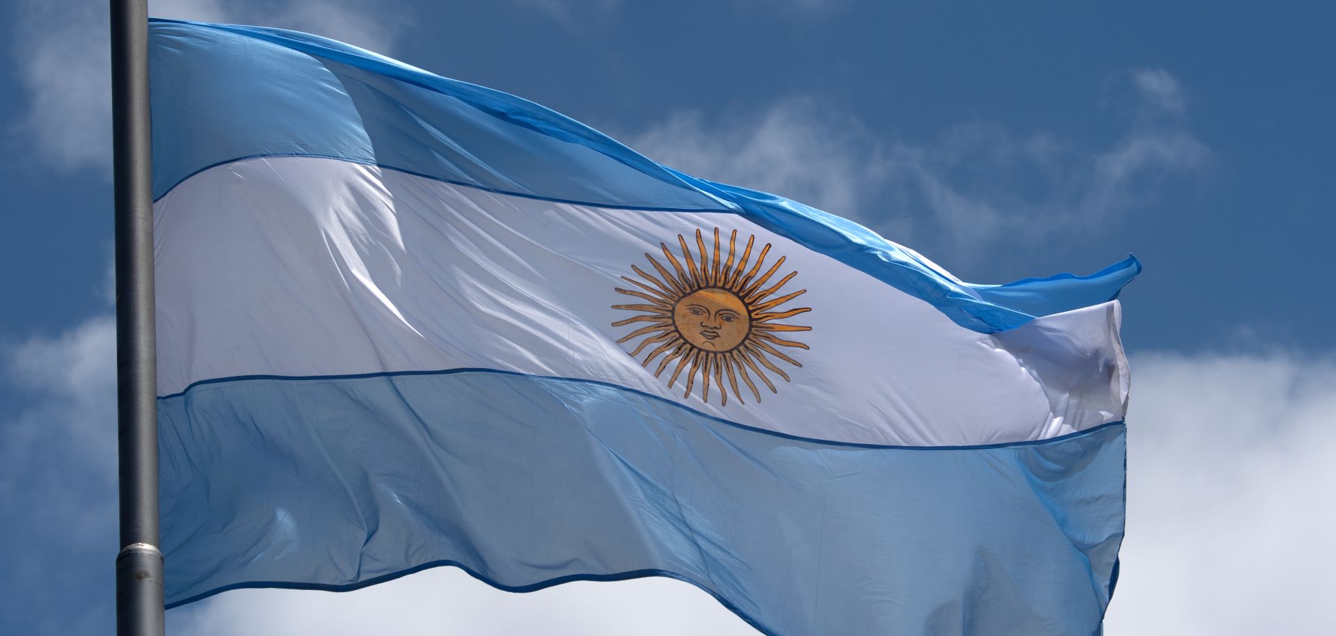 The national flag of Argentina flies above Avenida 9 de Julio, one of the major arteries of Buenos Aires, on Nov. 28, 2018. 