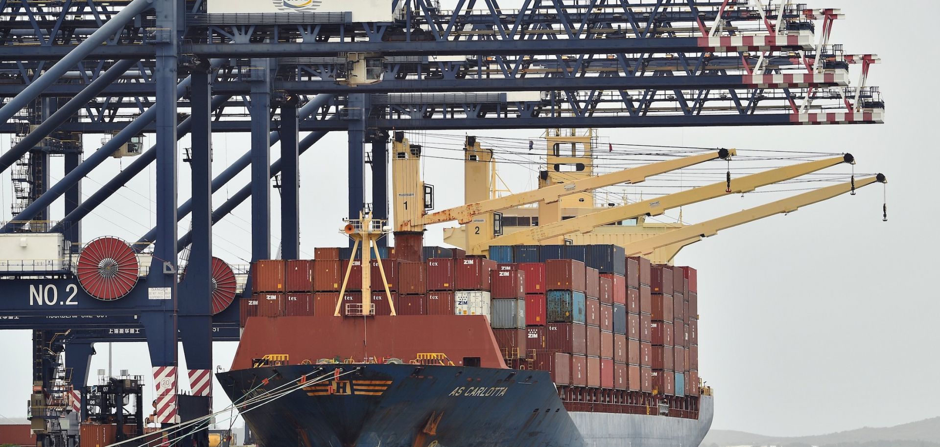 Workers load containers on a cargo ship at Port Botany in Sydney, Australia, on Dec. 2, 2020. 