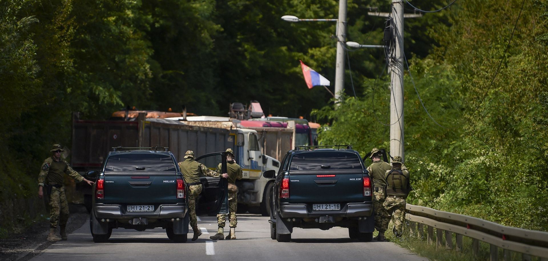 NATO soldiers patrol a roadblock set up by ethnic Serbs near Zubin Potok, a town in northern Kosovo, on Aug. 1, 2022. 