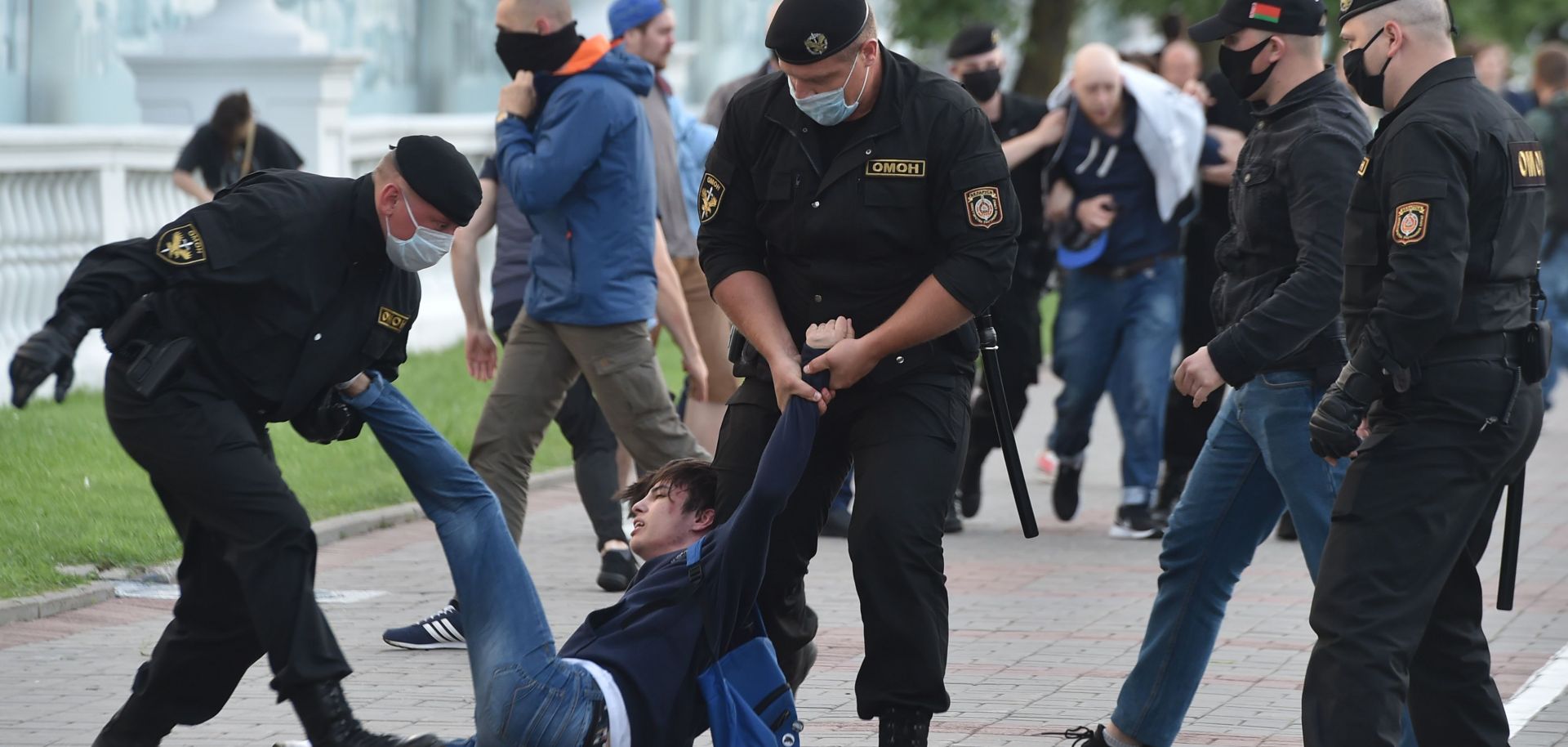Plainclothed Belarus' security forces and riot police officers detain a protester at an opposition demonstration in Minsk, Belarus, on July 14, 2020.