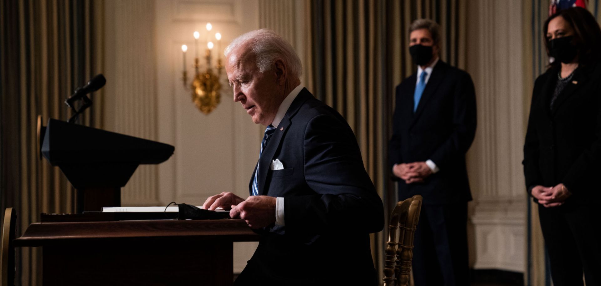U.S. President Joe Biden prepares to sign executive orders after speaking about climate change issues in the State Dining Room of the White House on Jan. 27, 2021 in Washington D.C.  Behind him stands Special Presidential Envoy for Climate John Kerry (left) and Vice President Kamala Harris (right).