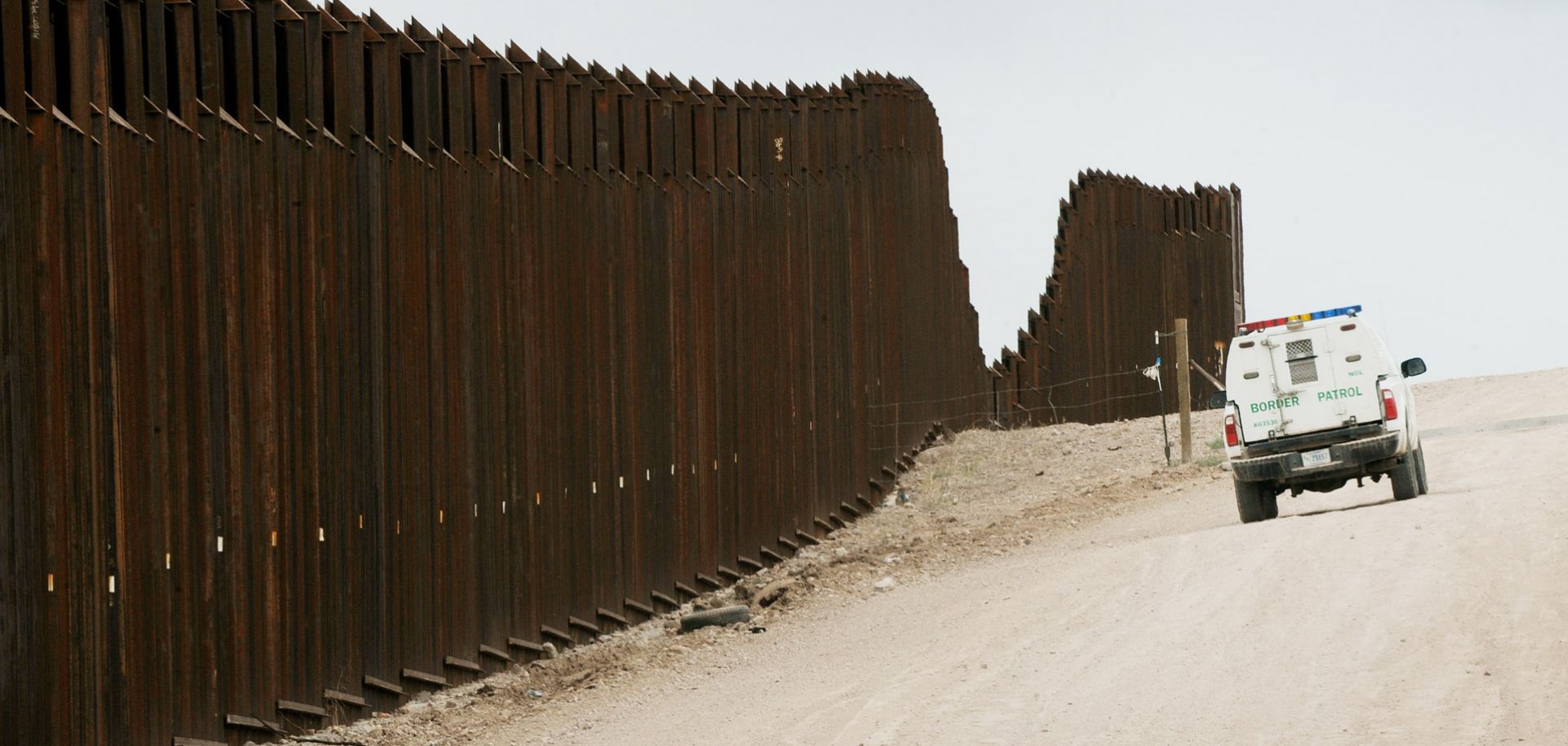 A US Border Patrol vehicle drives along the fence seperating the US from Mexico near the town of Nogales, Arizona on April 23, 2010. Two Republican senators have proposed sending 3,000 more US National Guard soldiers to quell violence spilling over the border between their home state of Arizona and Mexico. In a 10-point plan for beefing up security in the area, Senators John McCain and John Kyl also called for permanently adding 3,000 US Custom and Border Protection Agents to the Arizona/Mexico border by 20