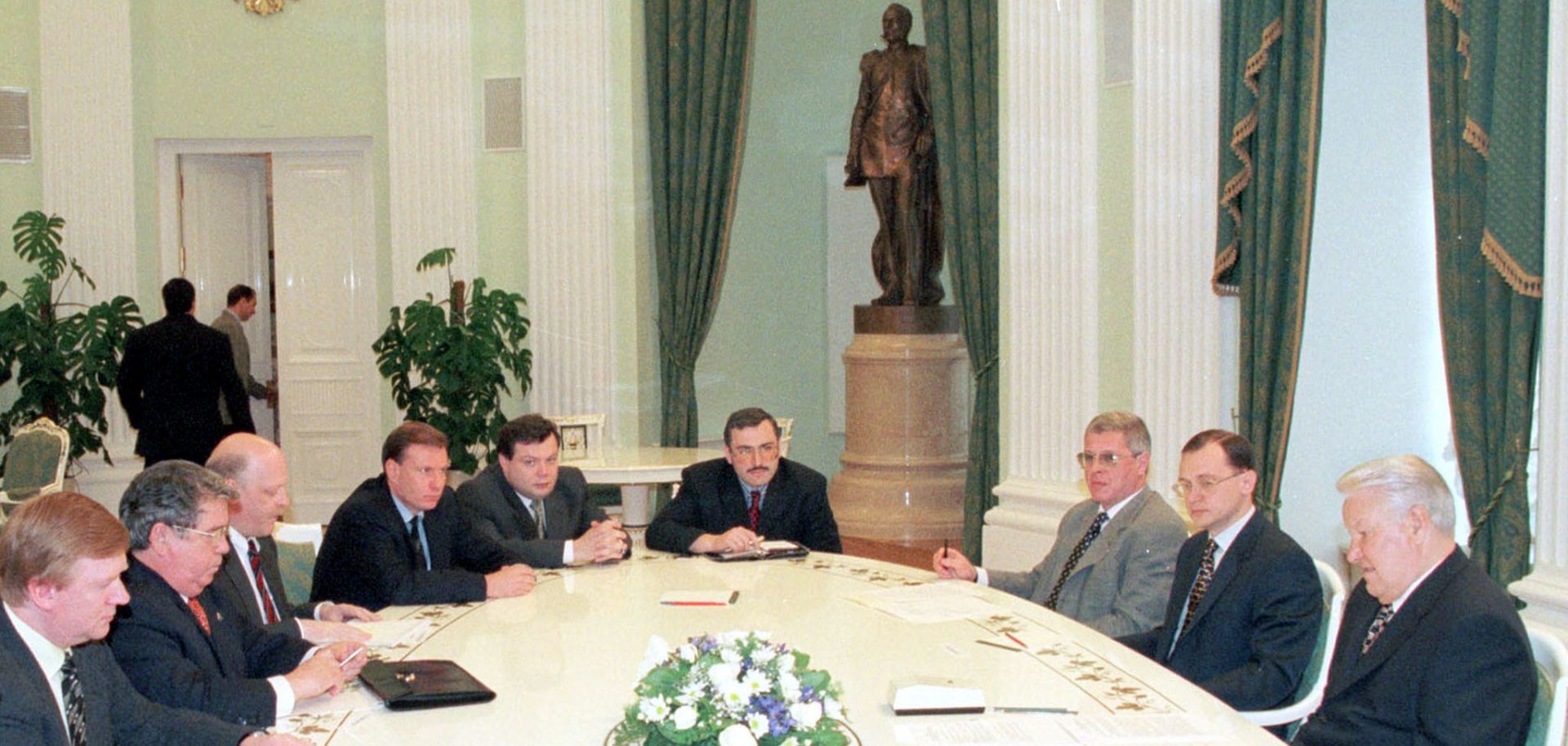 Russian president boris yeltsin sits in a meeting with leading national bankers.