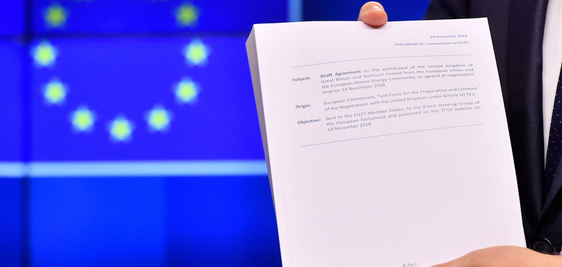 European Council President Donald Tusk holds the "draft agreement of the withdrawal of the United Kingdom of Great Britain and Northern Ireland from the European Union" during a press conference at the European Council in Brussels on Nov. 15.