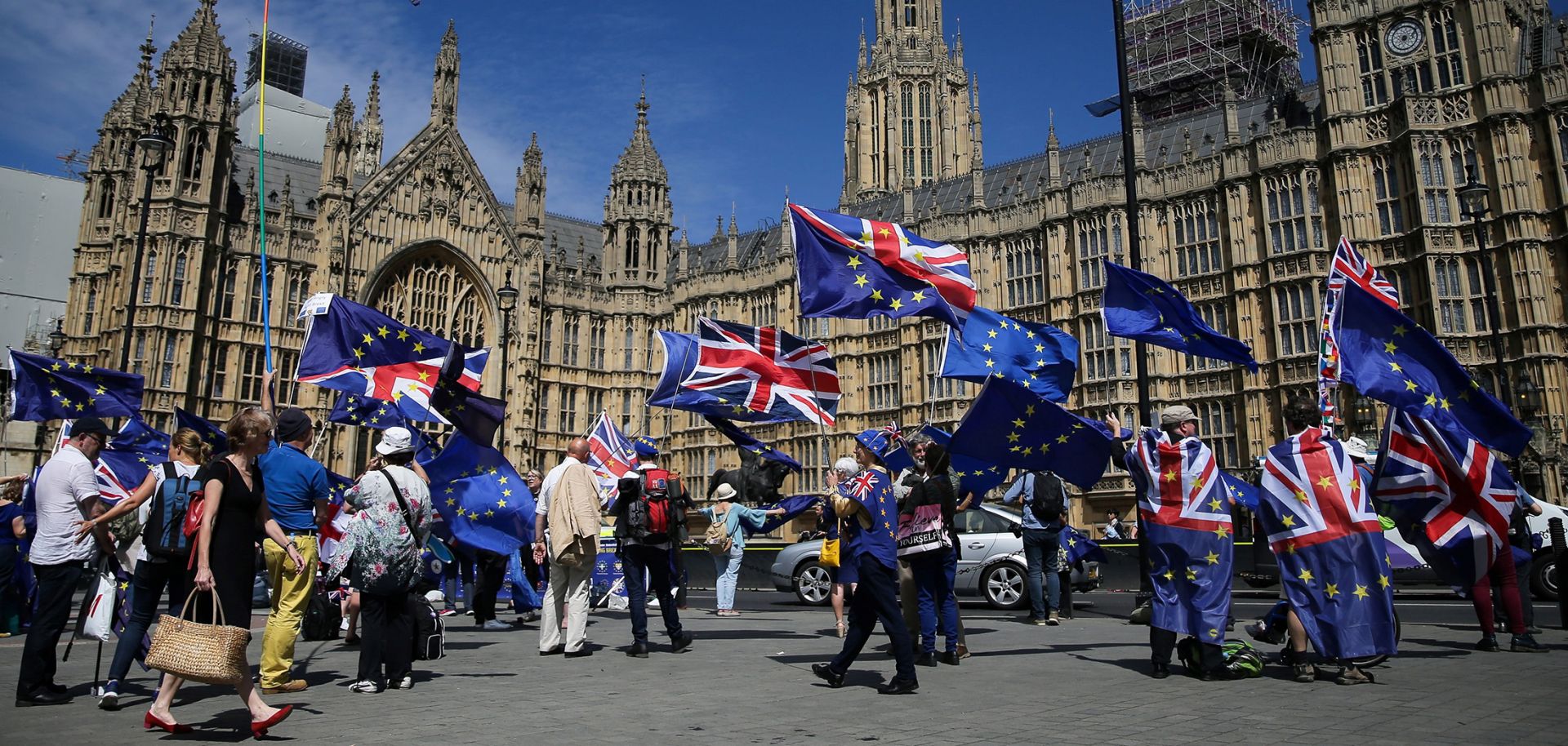 Pro-EU demonstrators hold placards and wave flags as they protest against Brexit, outside of the Houses of Parliament in central London on June 11, 2018.