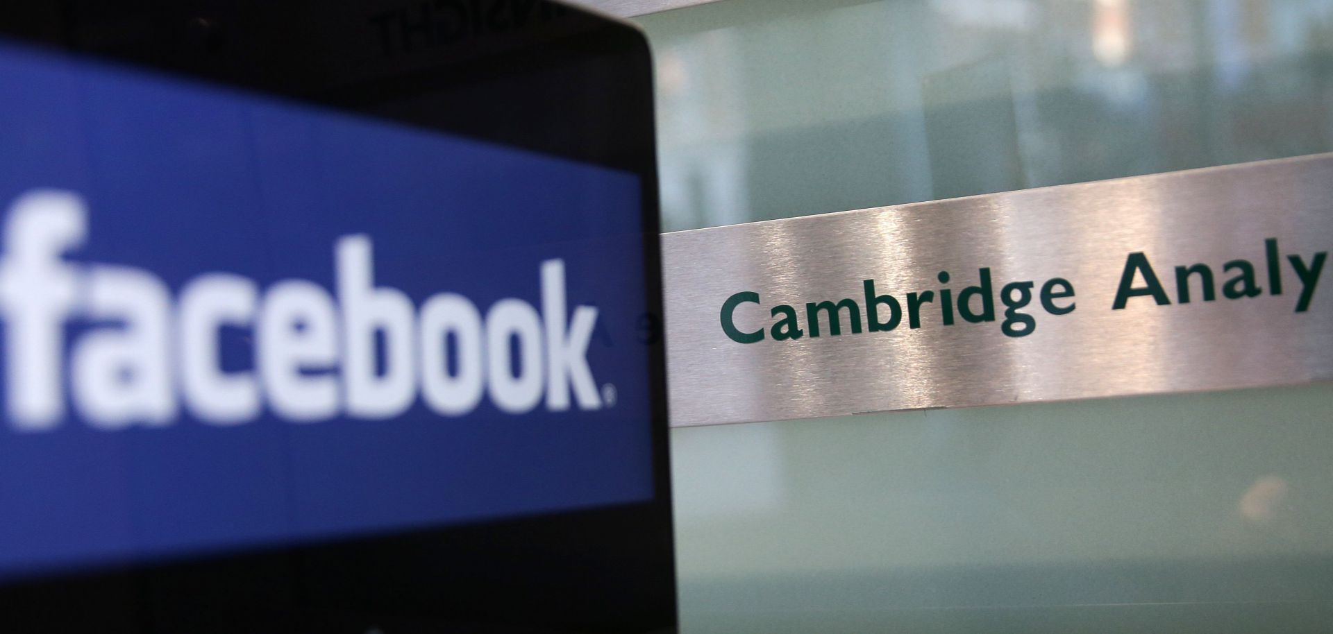 The Facebook logo appears on the screen of a laptop near the offices of Cambridge Analytica in London.