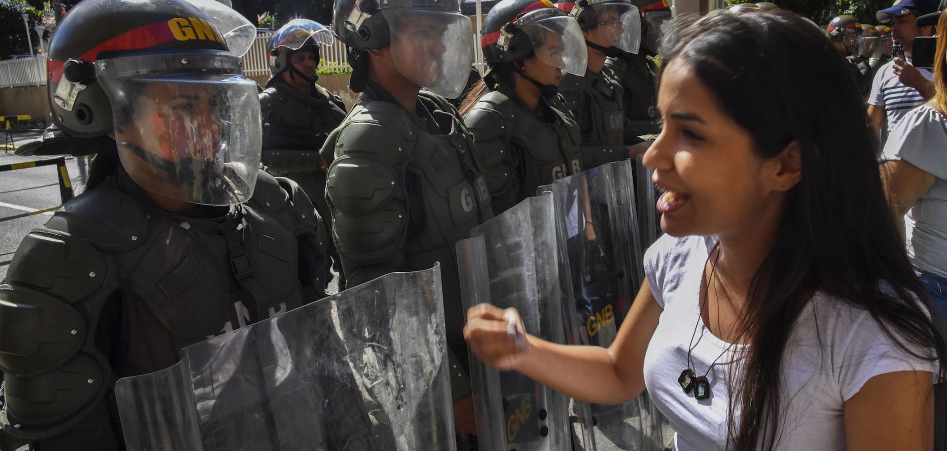 Members of the Bolivarian National Guard stand guard in Caracas