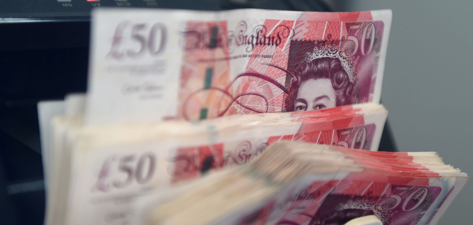 A counting machine tallies British pound notes Jan. 16, 2017, at a currency exchange in Kuala Lumpur, Malaysia. 