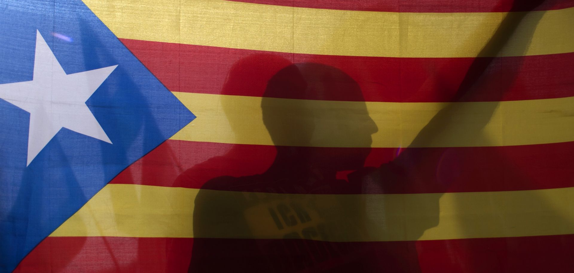 A protester in Granada, Spain, holds a Catalan flag to show his support for Catalonia's Oct. 1 independence referendum.