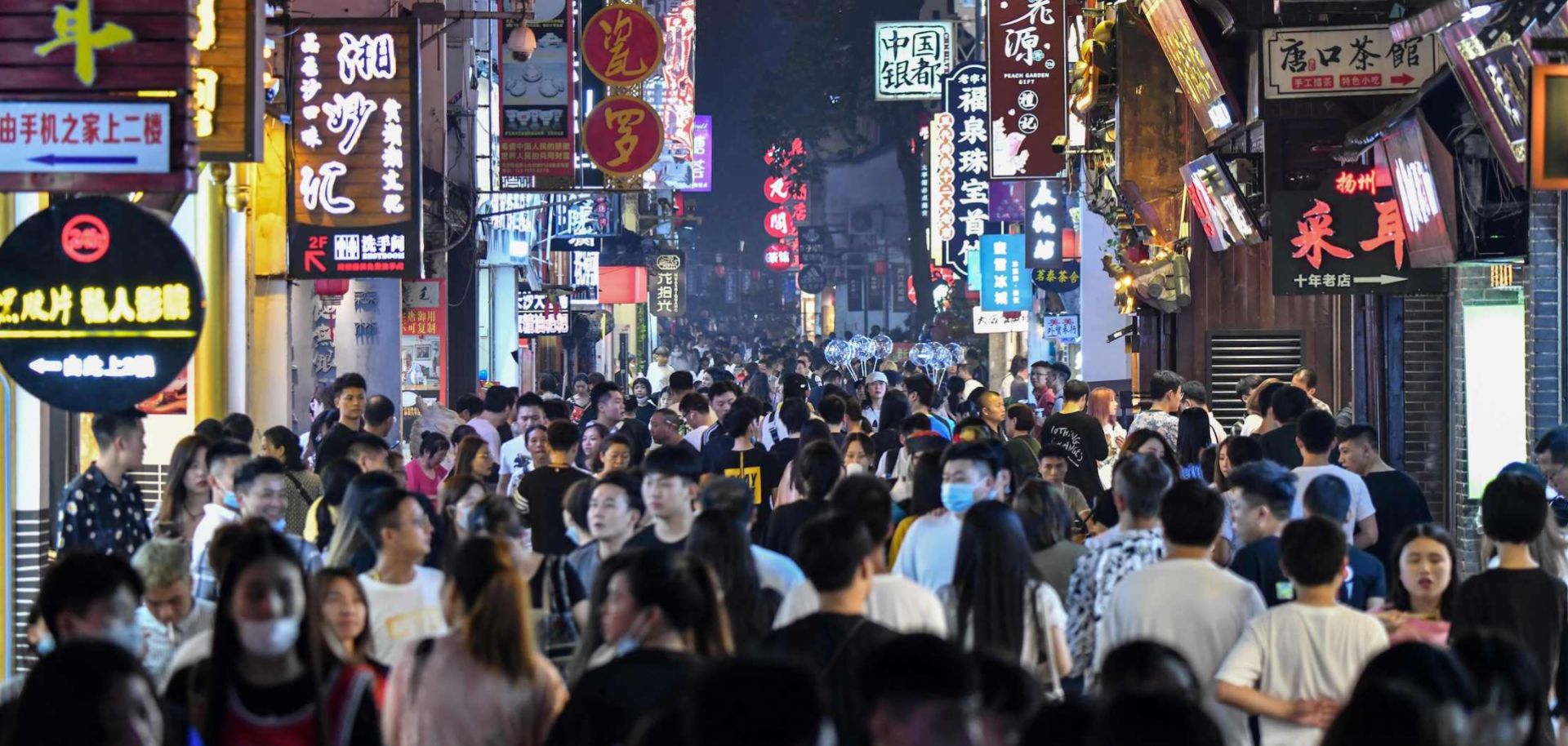 People walk along a pedestrian street surrounded by small shops in Changsha, China, on Sept. 7, 2020.