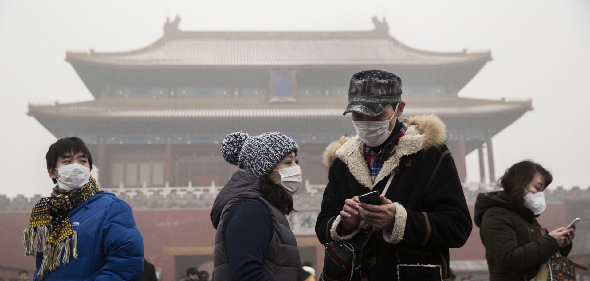 Chinese tourists wear masks to protect themselves from pollution outside the Forbidden City in Beijing.