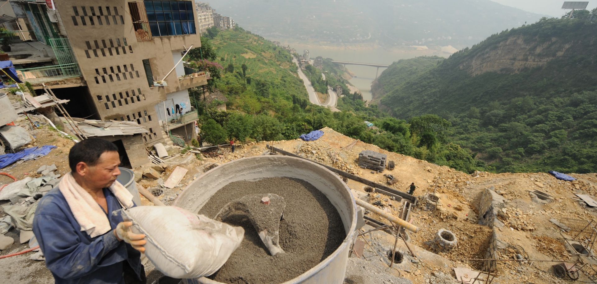 A worker in Badong, China, mixes cement.