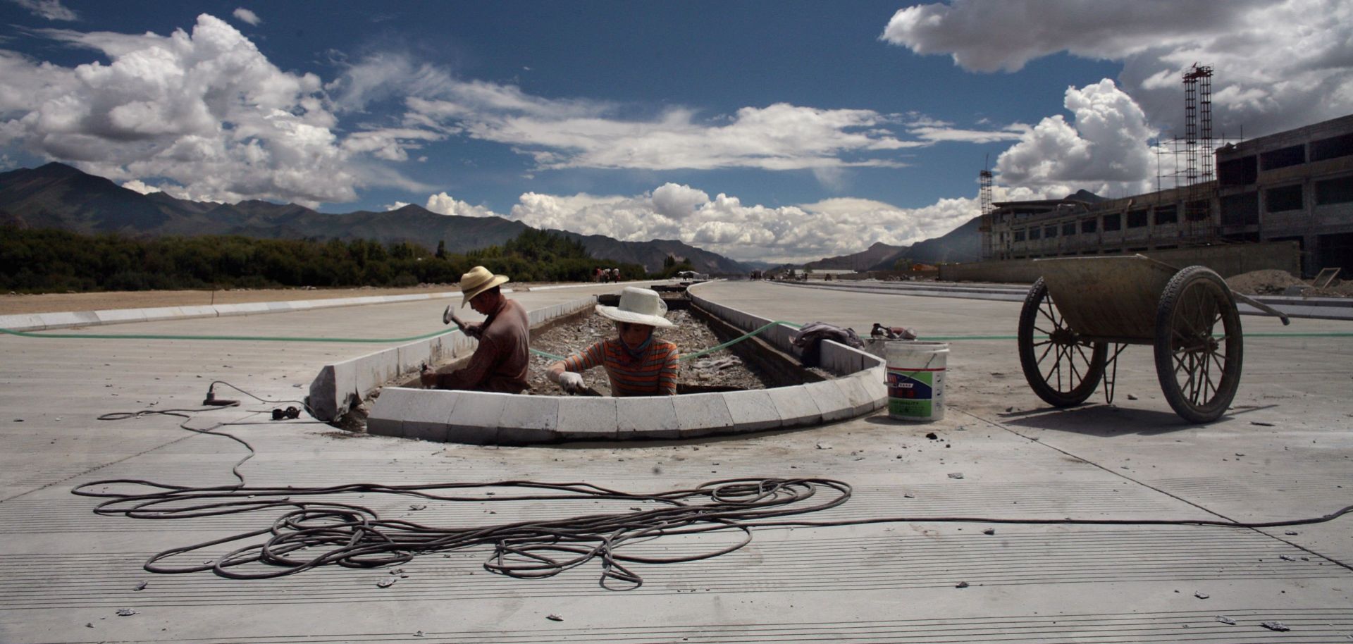 Workers in Tibet work to develop a road near Lhasa. China's drive for infrastructure improvements in the region has given it an advantage over India in a dispute over their disputed border.