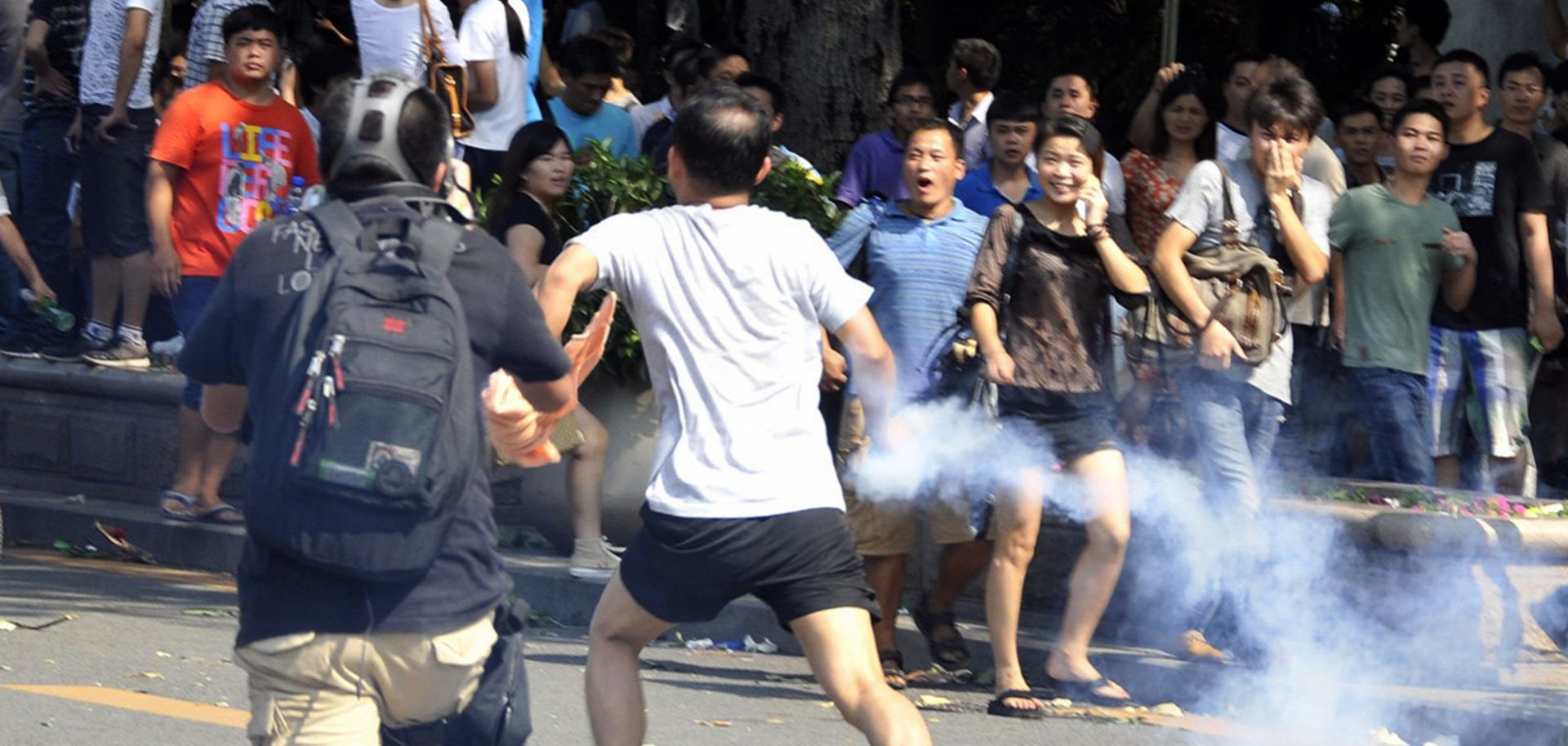 This picture shows a Chinese demonstrator throwing back a tear gas bottle during an anti-Japan protest in September 2012. 