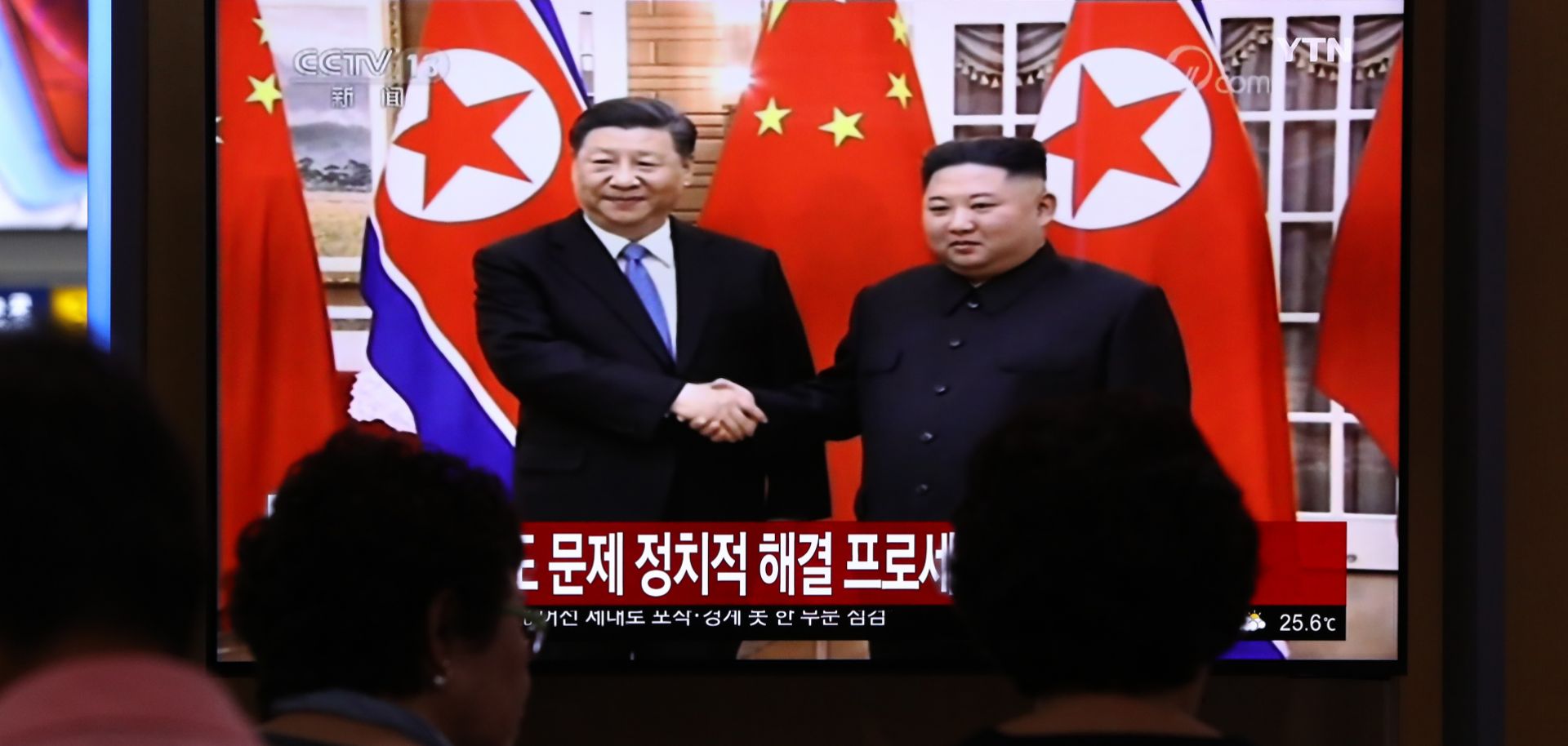 Chinese President Xi Jinping and North Korean leader Kim Jong Un are shown on a railway television monitor in Seoul, South Korea, on June 20, 2019.