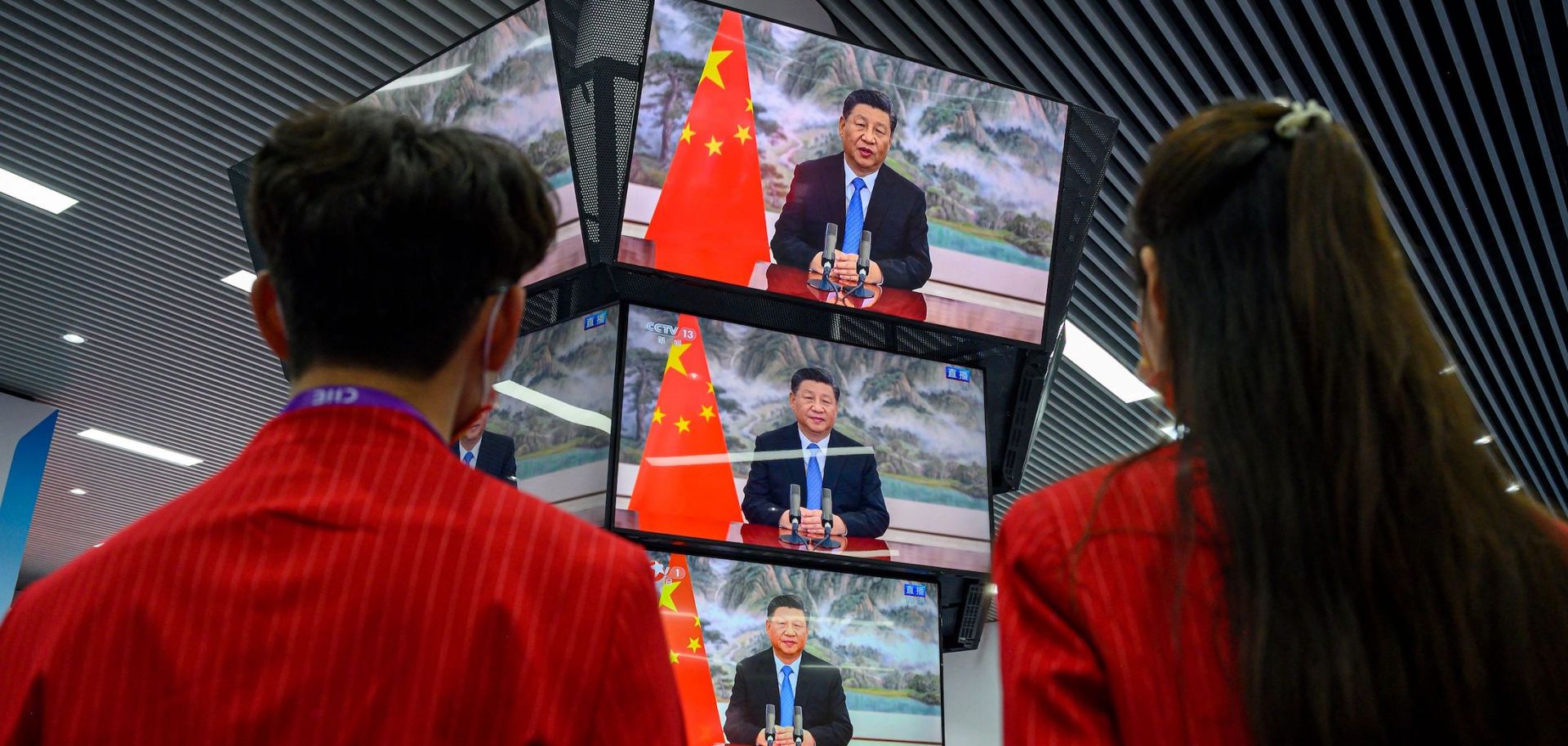 People watch Chinese President Xi Jinping speak during the opening ceremony of the China International Import Expo on Nov. 4, 2021, in Shanghai.