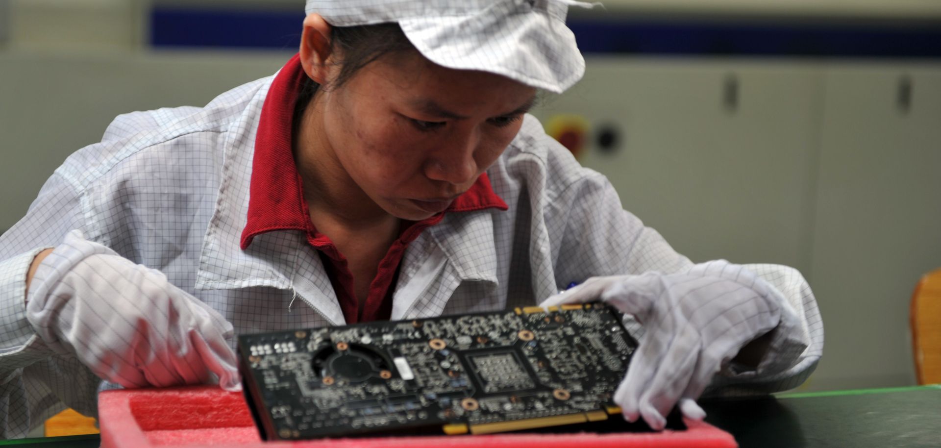 A worker inspects motherboards on a factory line at the Foxconn plant in Shenzhen, China, in 2010.