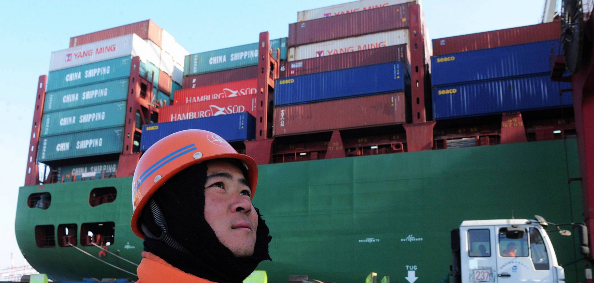 A worker watches cranes at the port in Qingdao, China, on Feb. 15.
