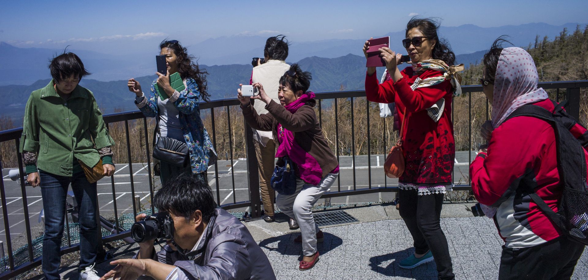 Chinese tourists take photographs at Mount Fuji in Japan. 