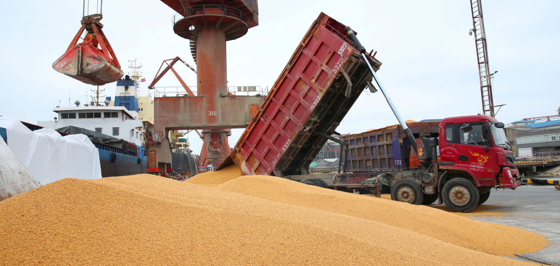 Workers load imported soybeans onto a truck at a port in Nantong in China's eastern Jiangsu province. Chinese soybean stocks are at a 10-year high, which could help China absorb the loss of U.S. imports brought on by tariffs.