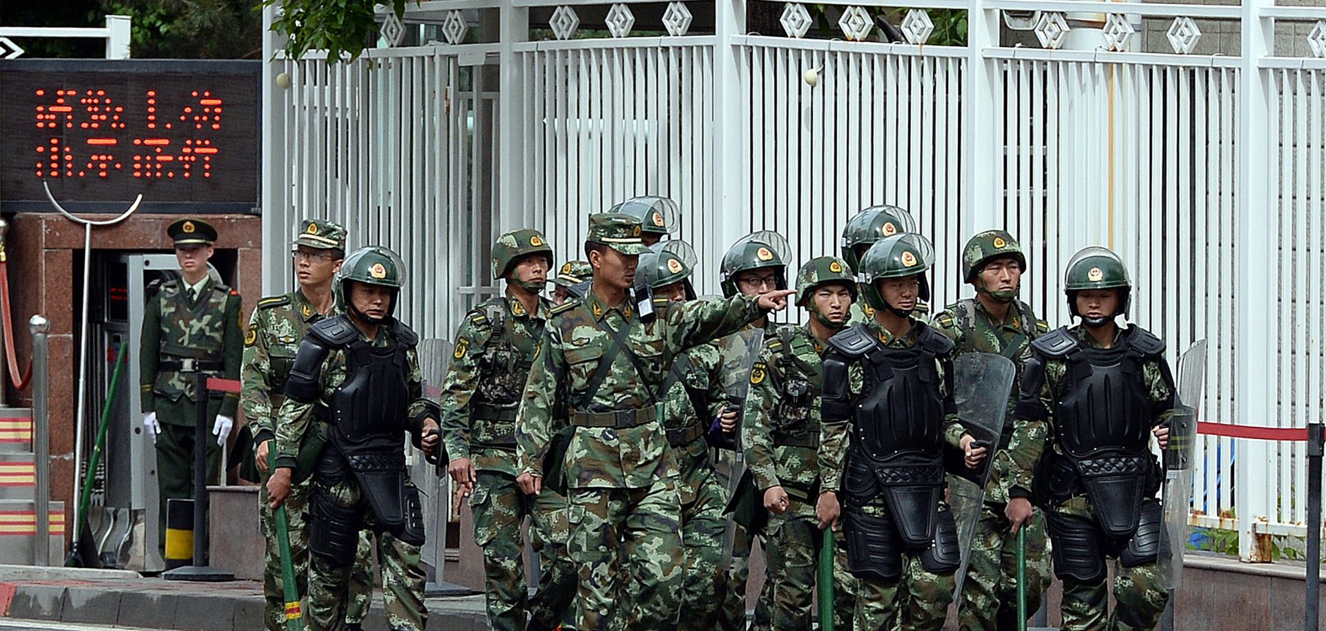Fully armed Chinese paramilitary police patrol a street in Urumqi.