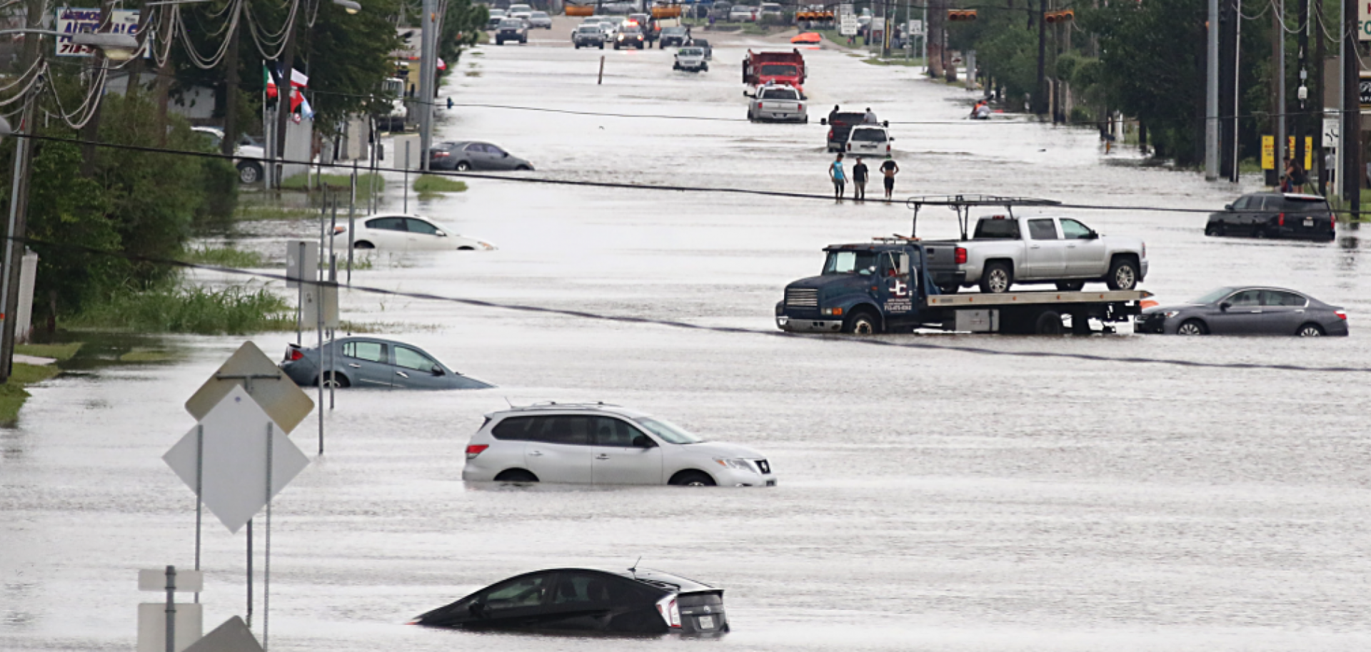 Cars and trucks sit swamped in floodwaters in Houston.