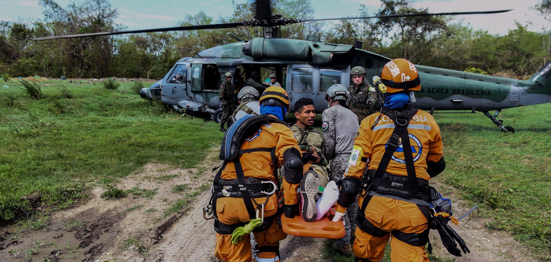 A Colombian rescue crew evacuates a "victim" in a Brazilian air force helicopter during an earthquake simulation exercise conducted by air force members at the Palenquero base in Puerto Salgar, Colombia, on Sept. 6, 2018.