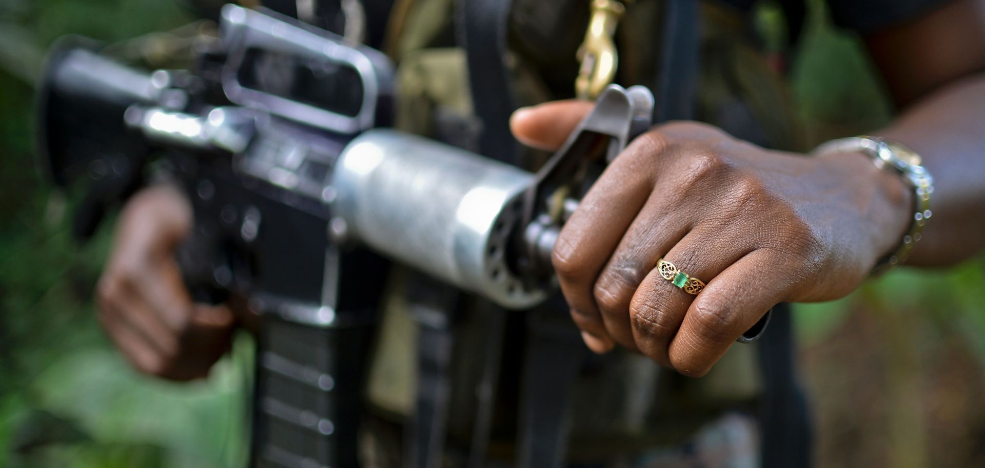 A guerrilla in the National Liberation Army, Colombia's second-largest leftist militant group, keeps her rifle close during an interview with AFP.