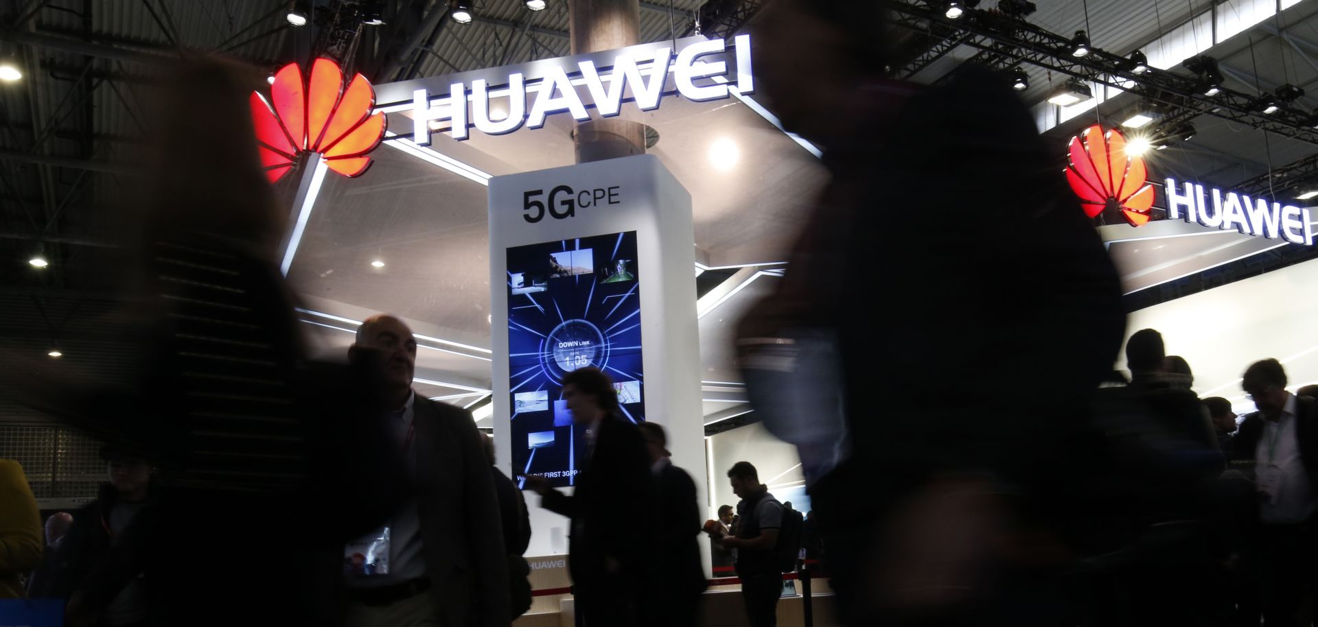 Conference attendees walk past a booth for Chinese telecommunications company at the Mobile World Congress in Barcelona, Spain. Huawei has not drawn the concern in Europe that it has in the United States.