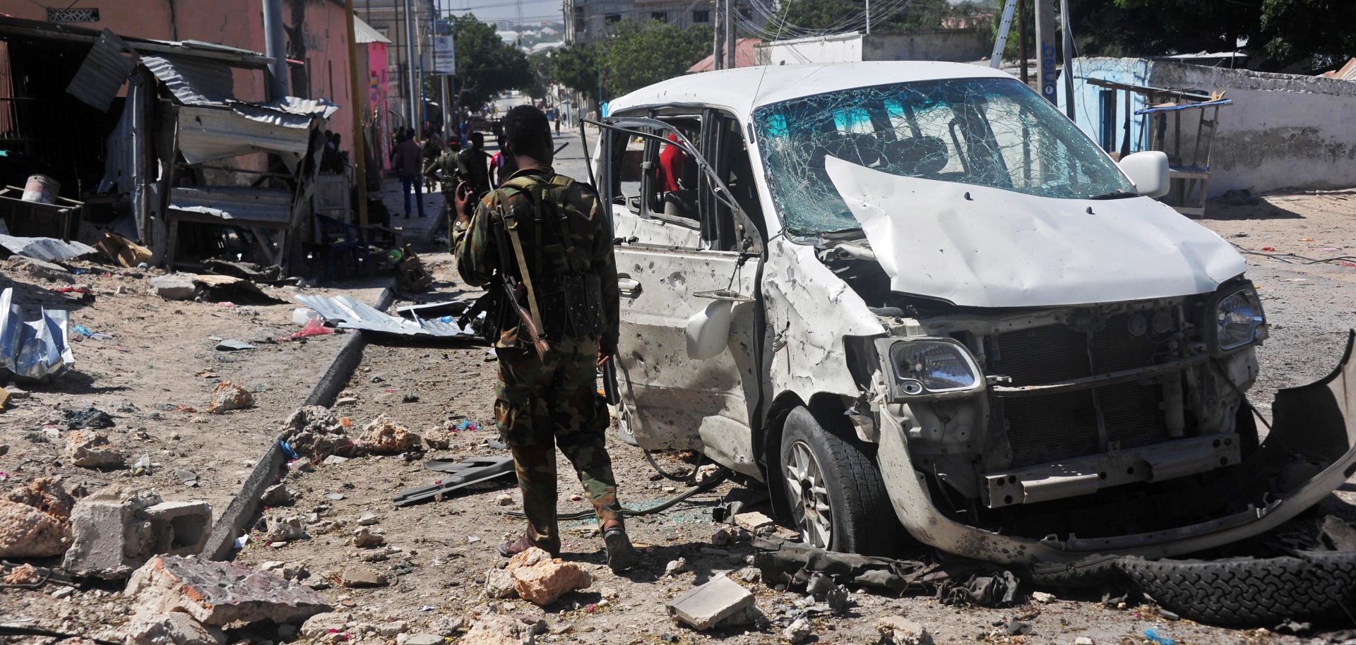 A Somali soldier stands at the scene of a car bomb attack conducted by al Qaeda affiliate al Shabaab near the Peace Hotel in Mogadishu on Jan. 2, 2017. 