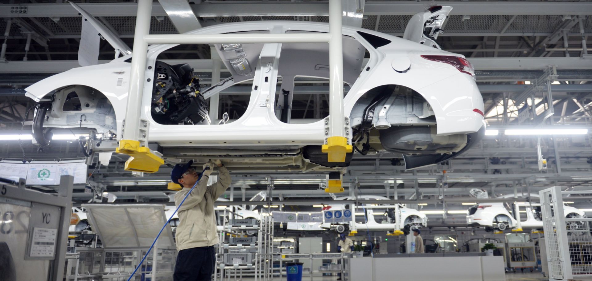 A worker assembles a vehicle in a Hyundai plant in China's Hebei province. South Korean automakers have increased their manufacturing capacity in China to  A significant proportion of South Korea's auto manufacturing capacity in China to 2.1 million vehicles annually.