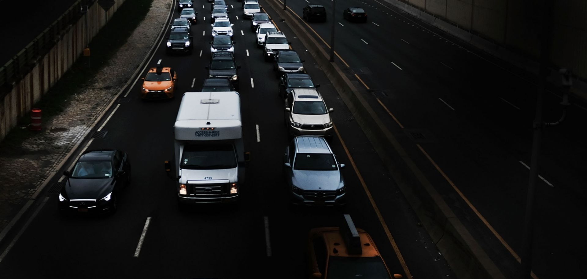 This image shows vehicles traveling through Brooklyn. The White House will decide soon whether to claim the power to impose tariffs on auto imports it deems unfair.