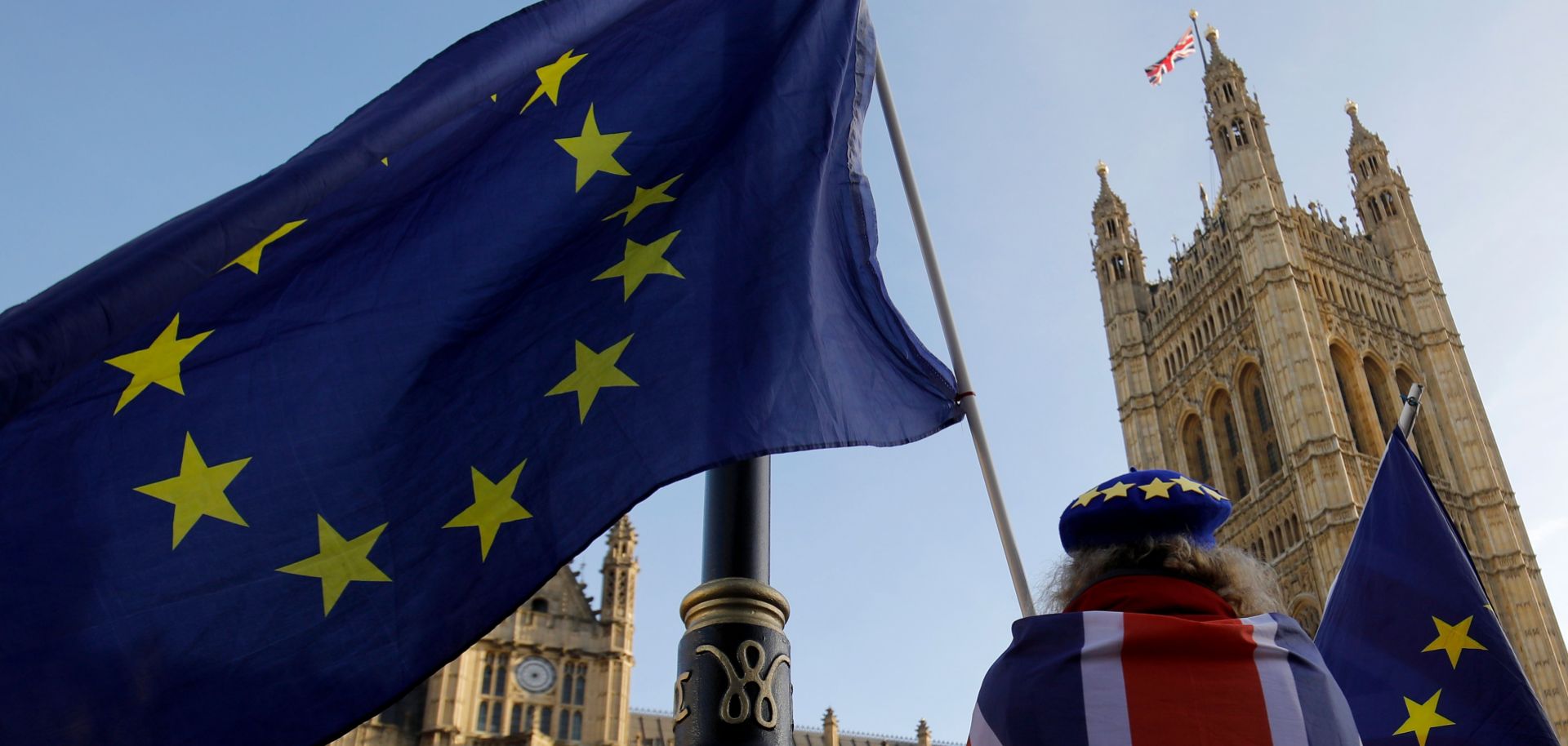 A Brexit opponent displays the Union Jack and the European Union flag outside the Houses of Parliament in London on Dec. 17, 2018.