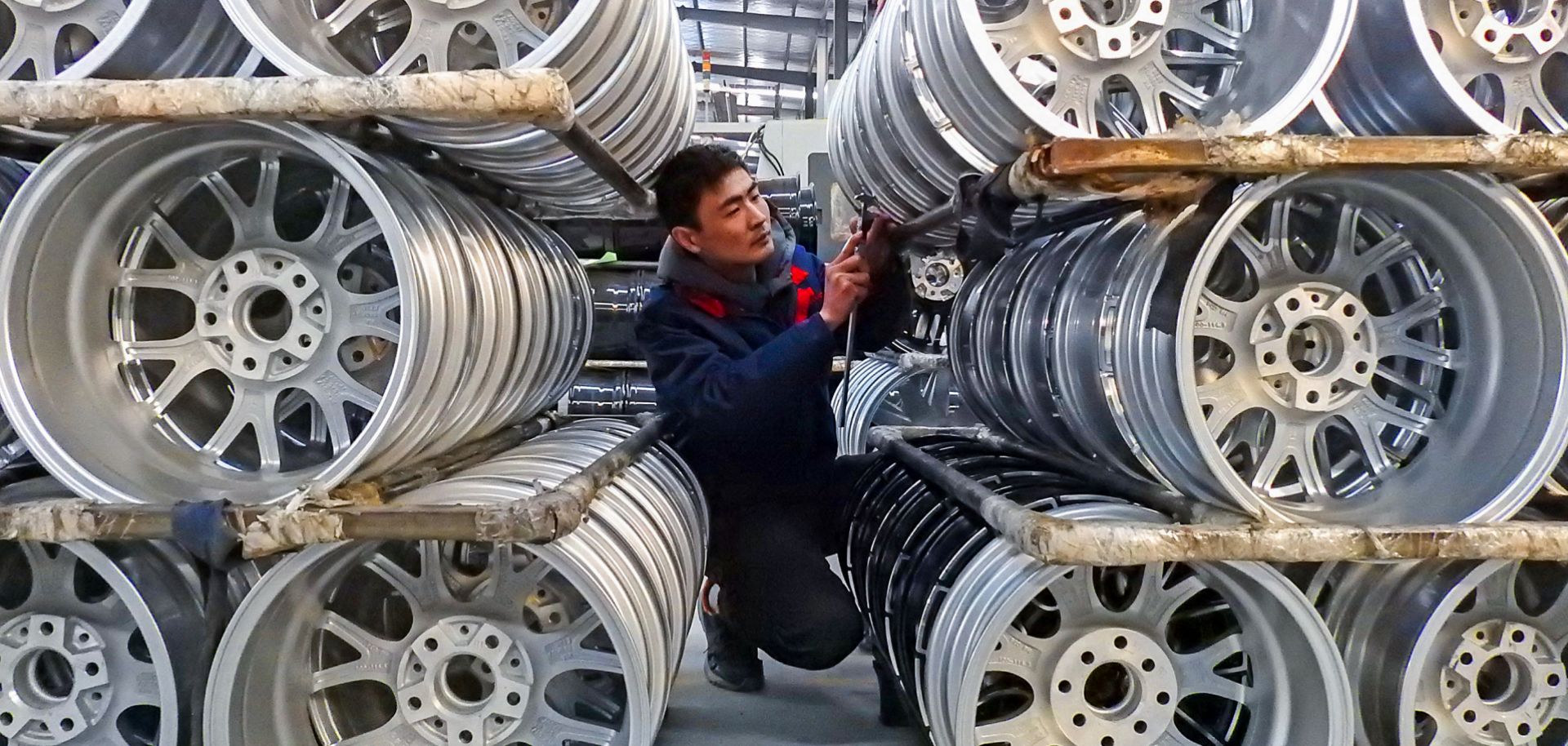 A Chinese worker checks wheels on Jan. 28, 2019, at a factory in Lianyungang, Jiangsu province.