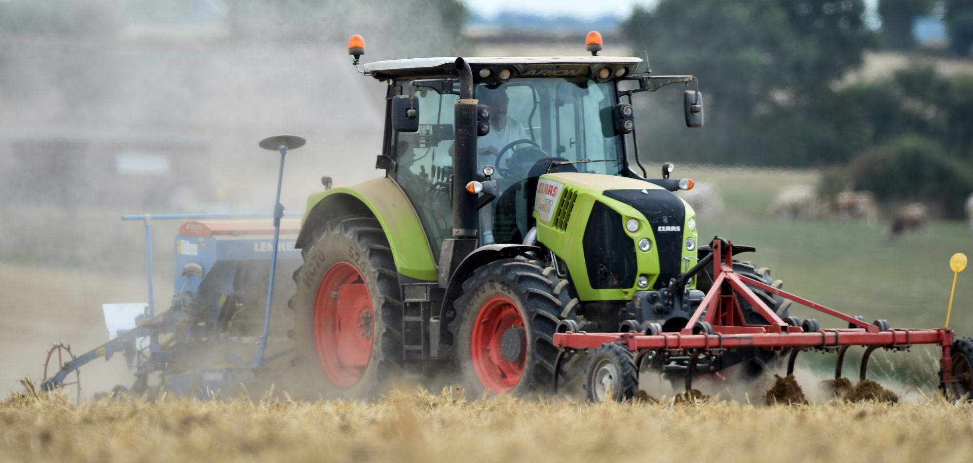 A farmer drives a tractor as he sows his field in a field near Bouloire north-western France on Aug. 21, 2018.