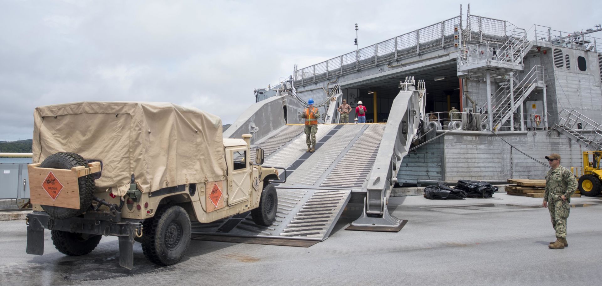 Sailors attached to Navy Cargo Handling Battalion 1 with Detachment Guam move supplies from a naval base in Guam to the fast transport ship USNS Brunswick on Sept. 1, 2018.