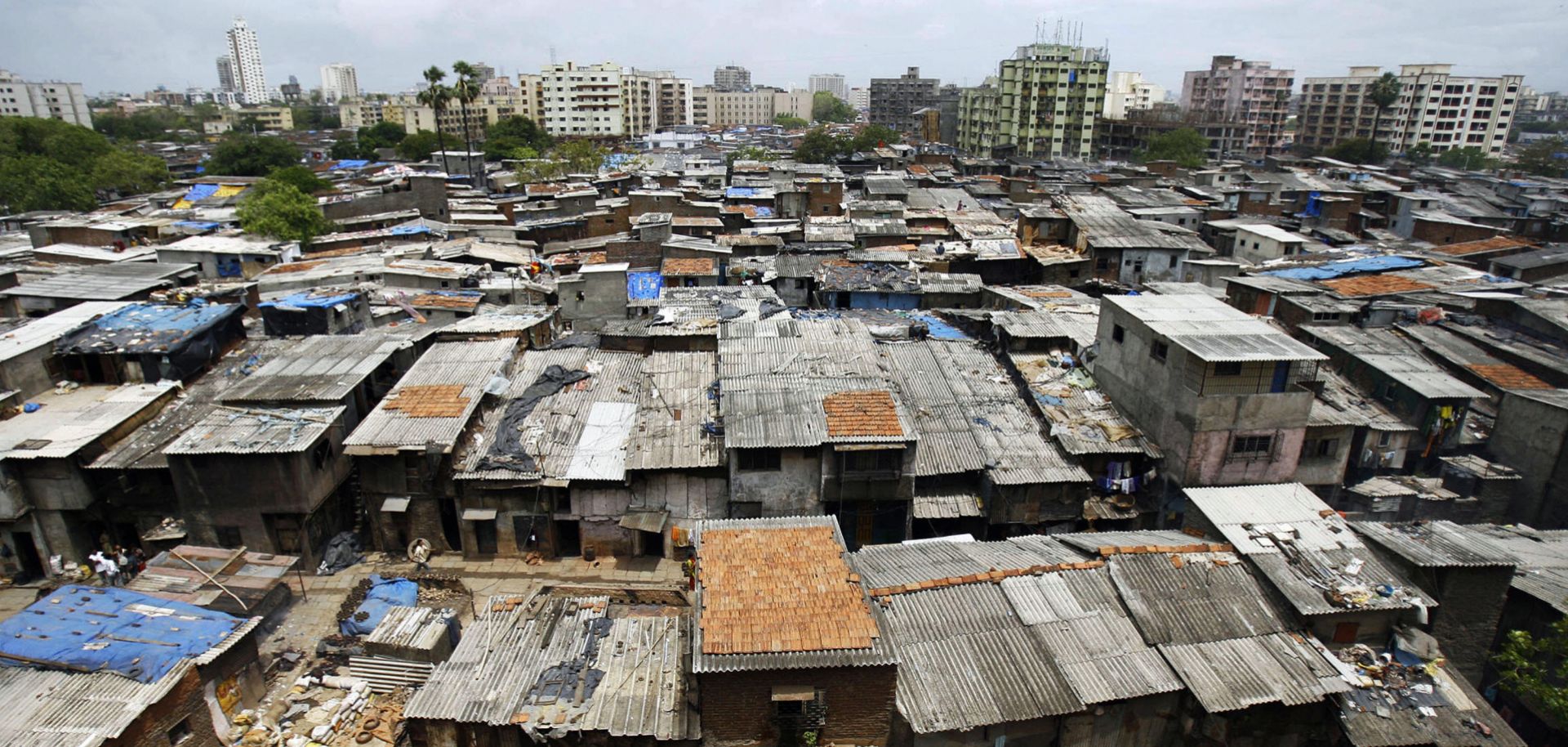 In this 2007 photograph, office blocks and residential buildings tower over the notorious slum colony of Dharavi in Mumbai, India.