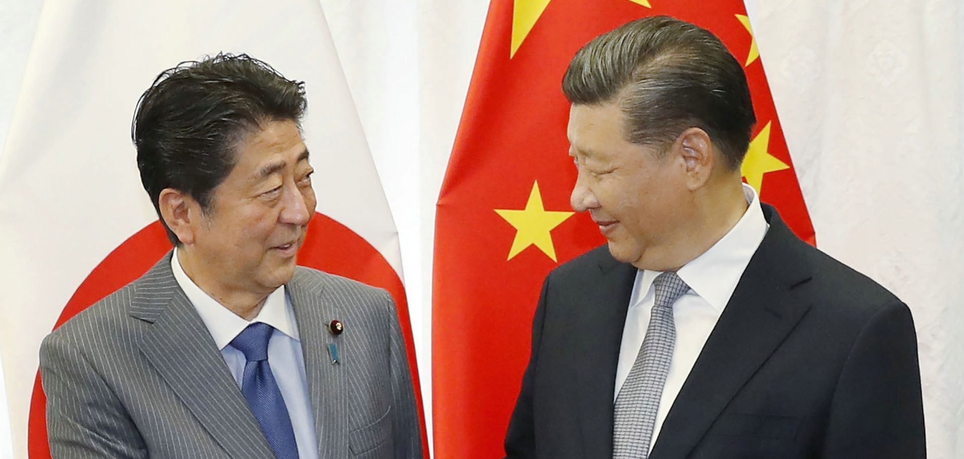 Japanese Prime Minister Shinzo Abe shakes hands with Chinese President Xi Jinping before a bilateral meeting in Russia during the 2018 Eastern Economic Forum.