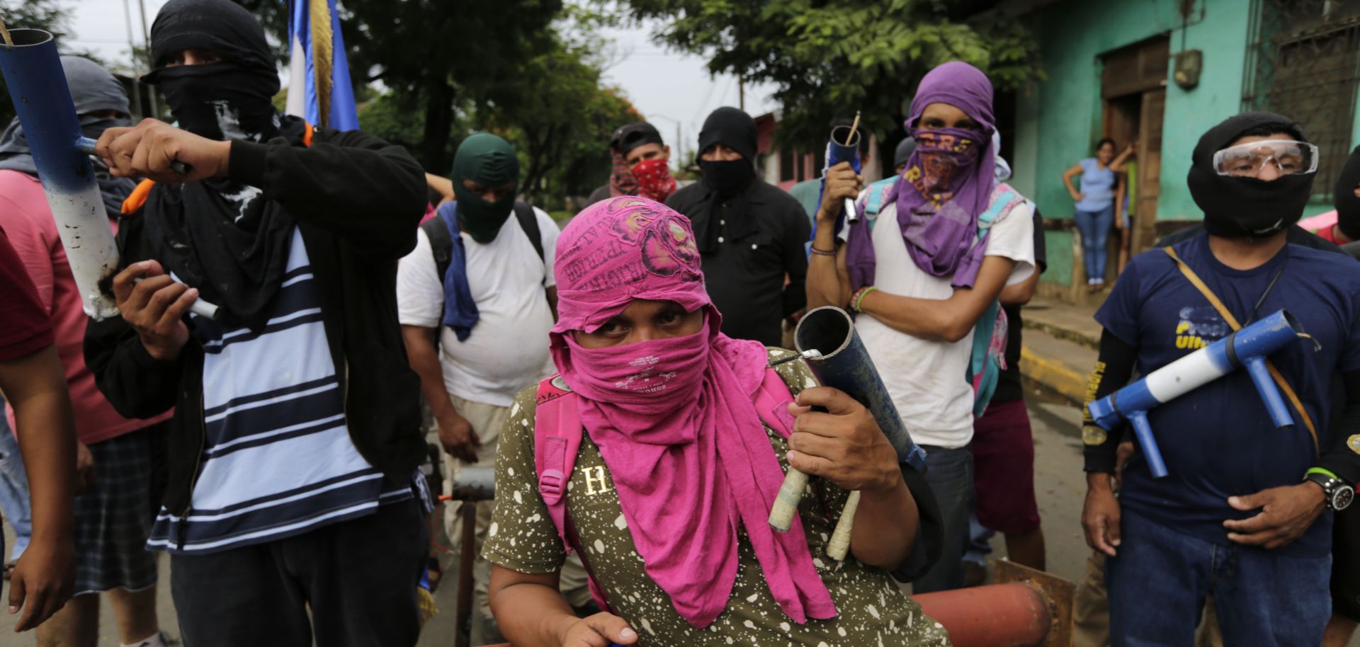 Anti-government demonstrators carry homemade mortars, as they stand near a barricade in Masaya, Nicaragua, on June 5.