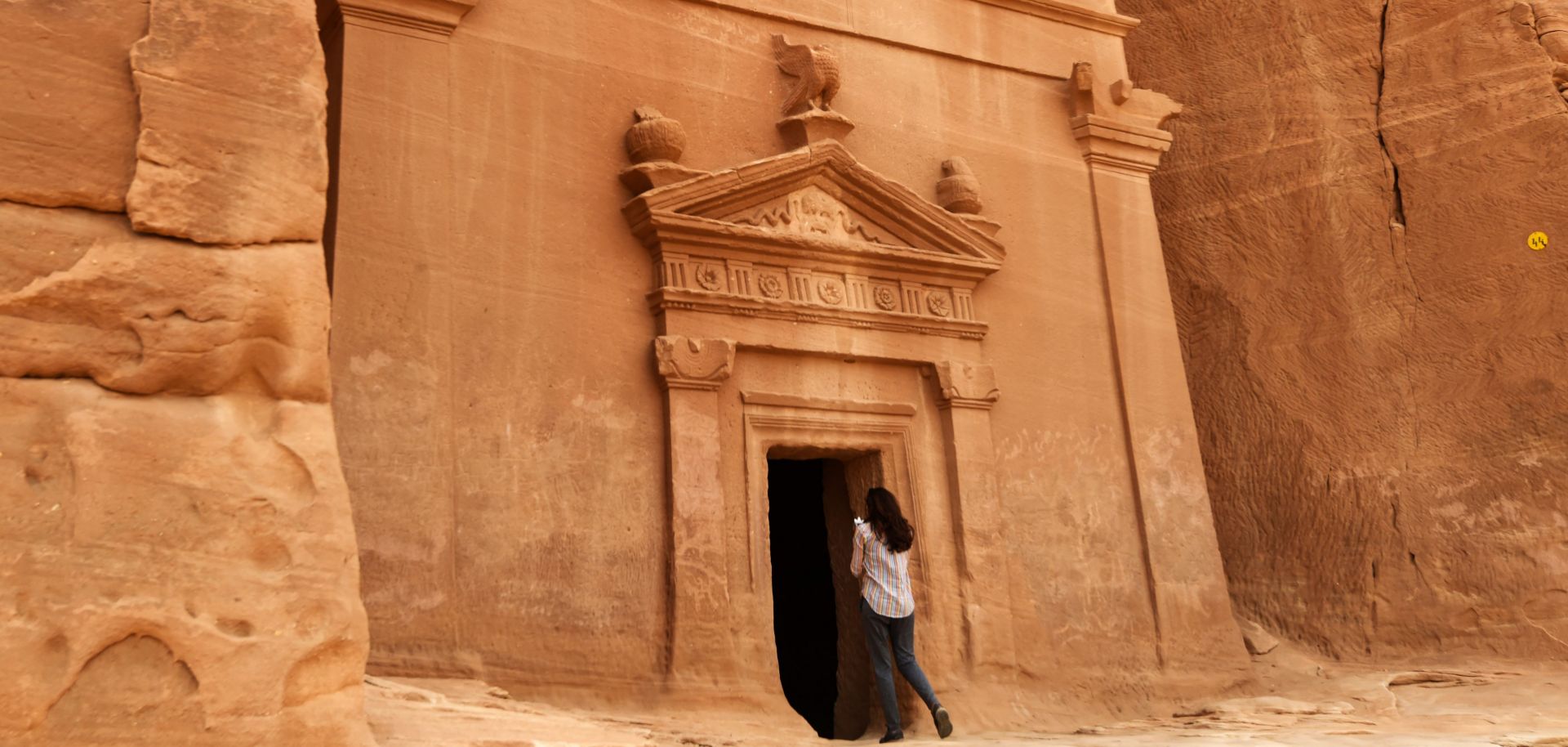 A journalist takes a picture of a tomb at Madain Saleh, a UNESCO World Heritage site, in Saudi Arabia's northwest on March 31, 2018.